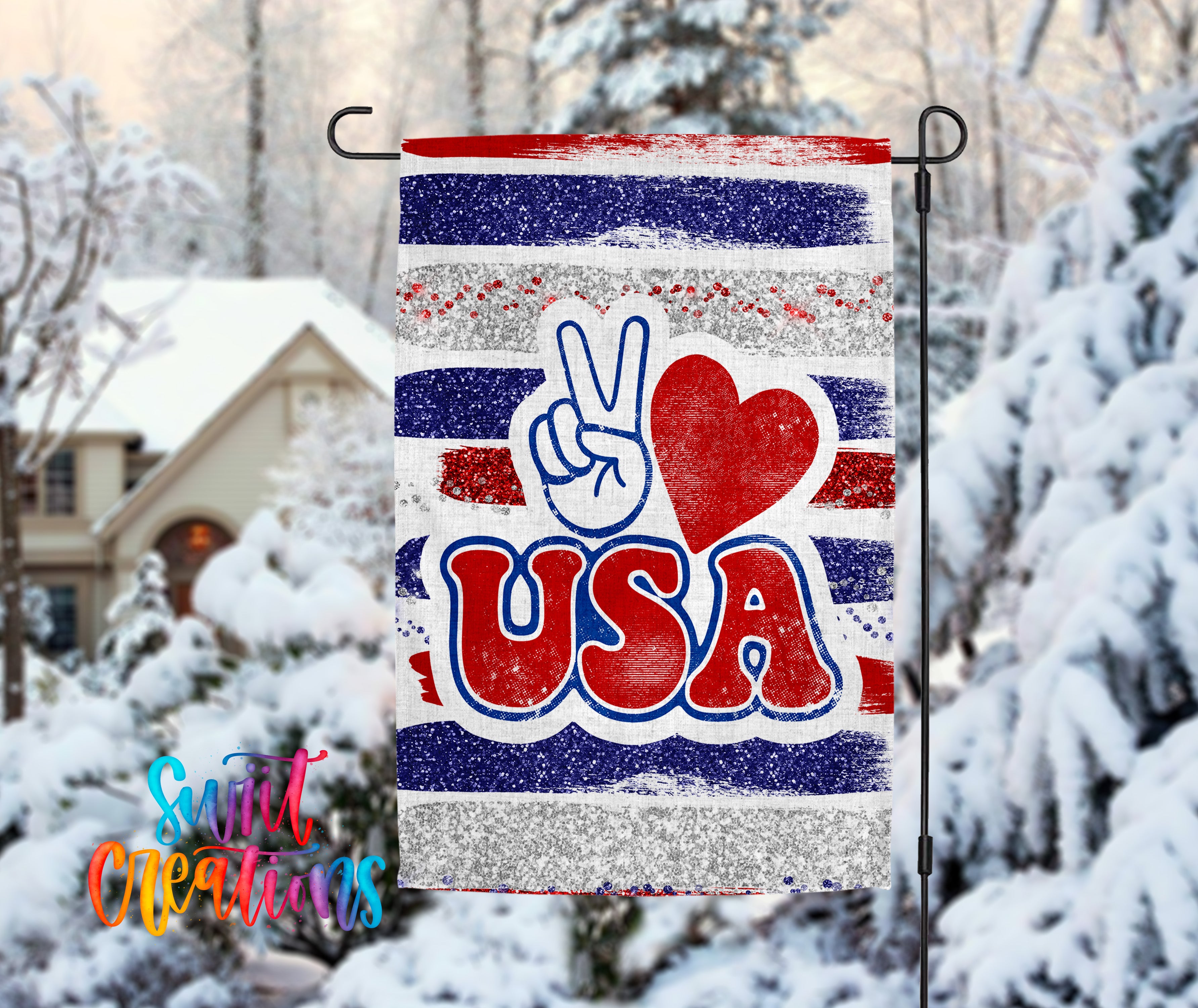A patriotic flag with the word "USA" prominently displayed, featuring a peace sign and a red heart symbol. The flag is hanging in a snowy outdoor setting, with a house and trees visible in the background.
