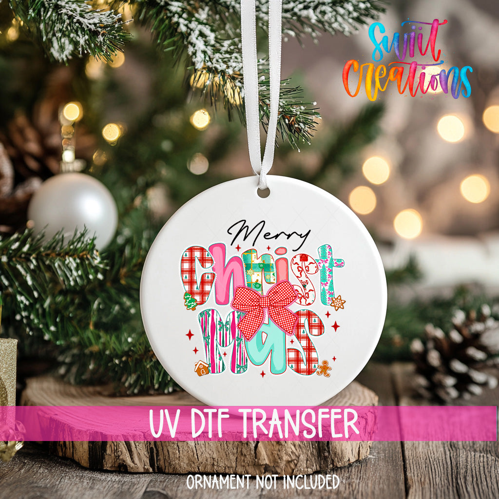 A white Christmas ornament with the text "Merry Christmas" and colorful decorative elements hangs on a tree.