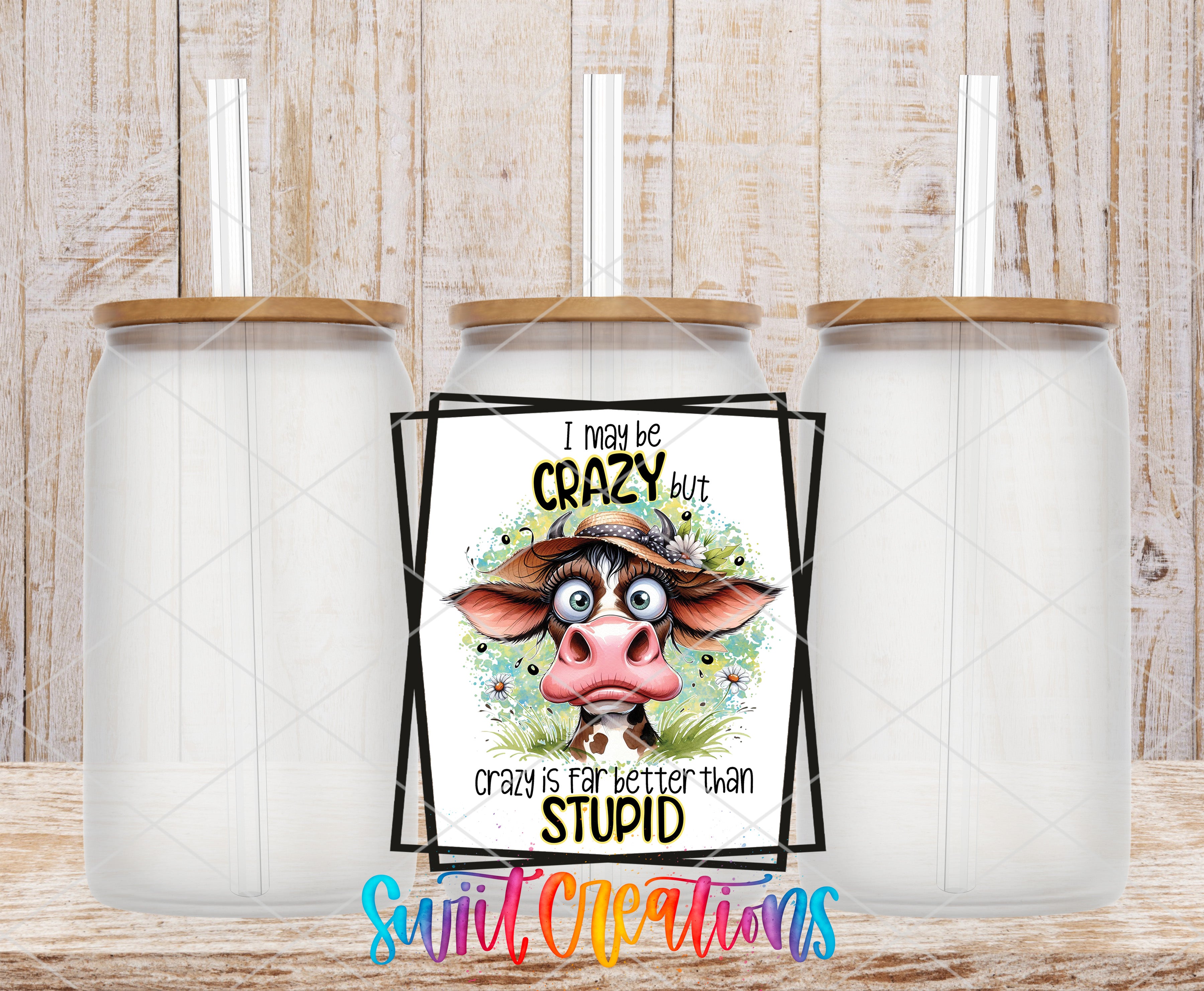 a humorous sign with a cow and the text "I may be crazy but crazy is far better than stupid" displayed in front of three glass jars.
