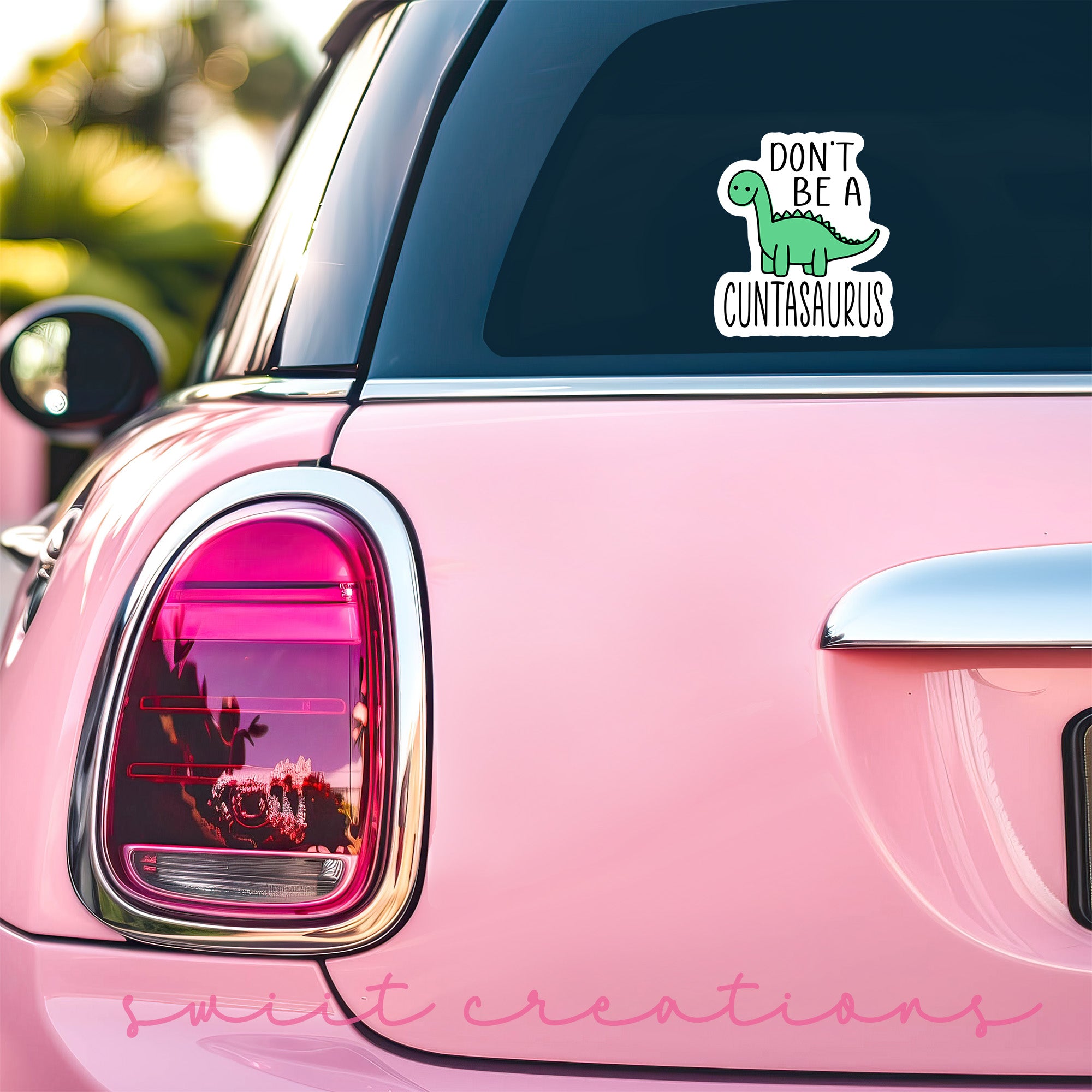 a pink car with a sticker that says don't be a dinosaur