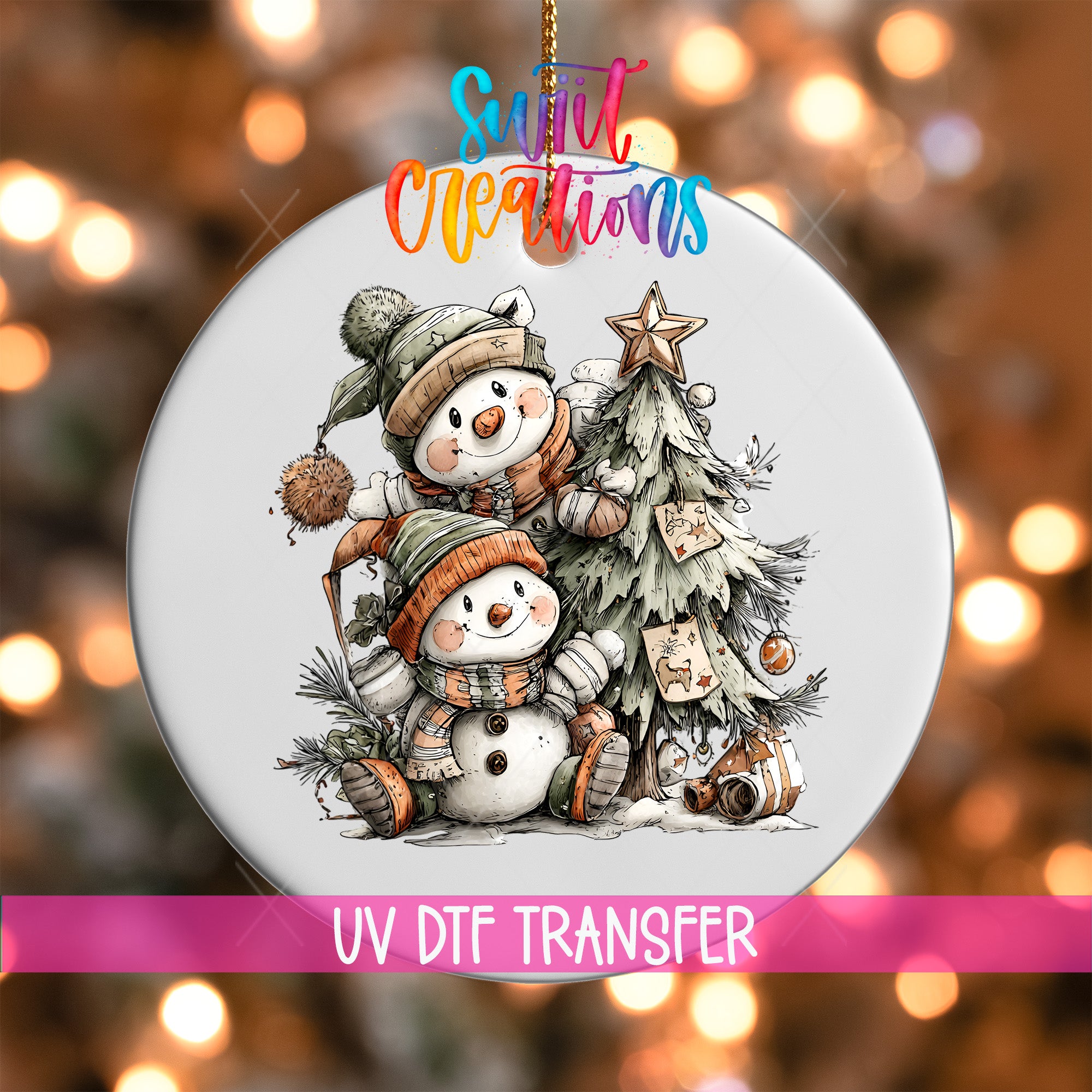 A Christmas ornament featuring two snowmen and a tree, with a colorful background and text indicating it is a UV DFT transfer.