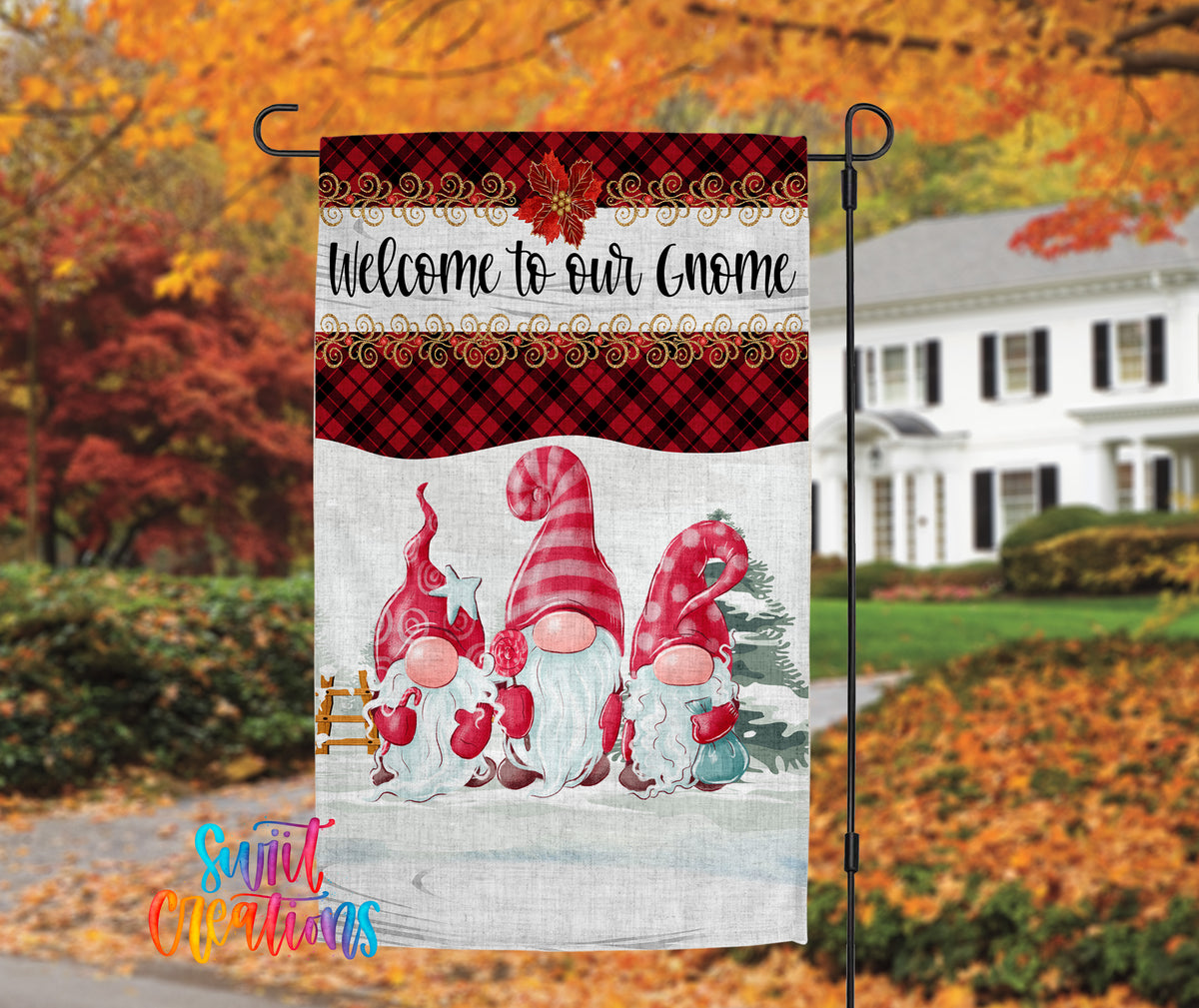 A banner with a festive design featuring three gnomes in a snowy landscape, with a house and autumn foliage in the background.