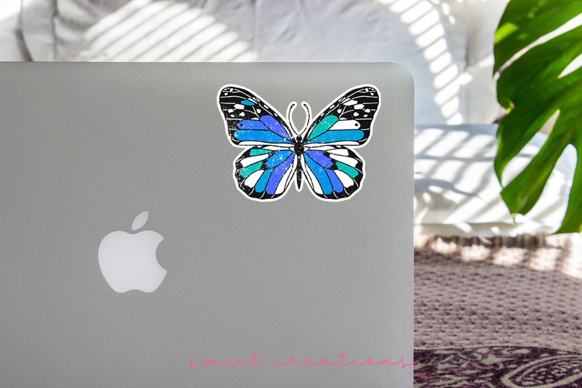 a laptop with a blue butterfly sticker on it