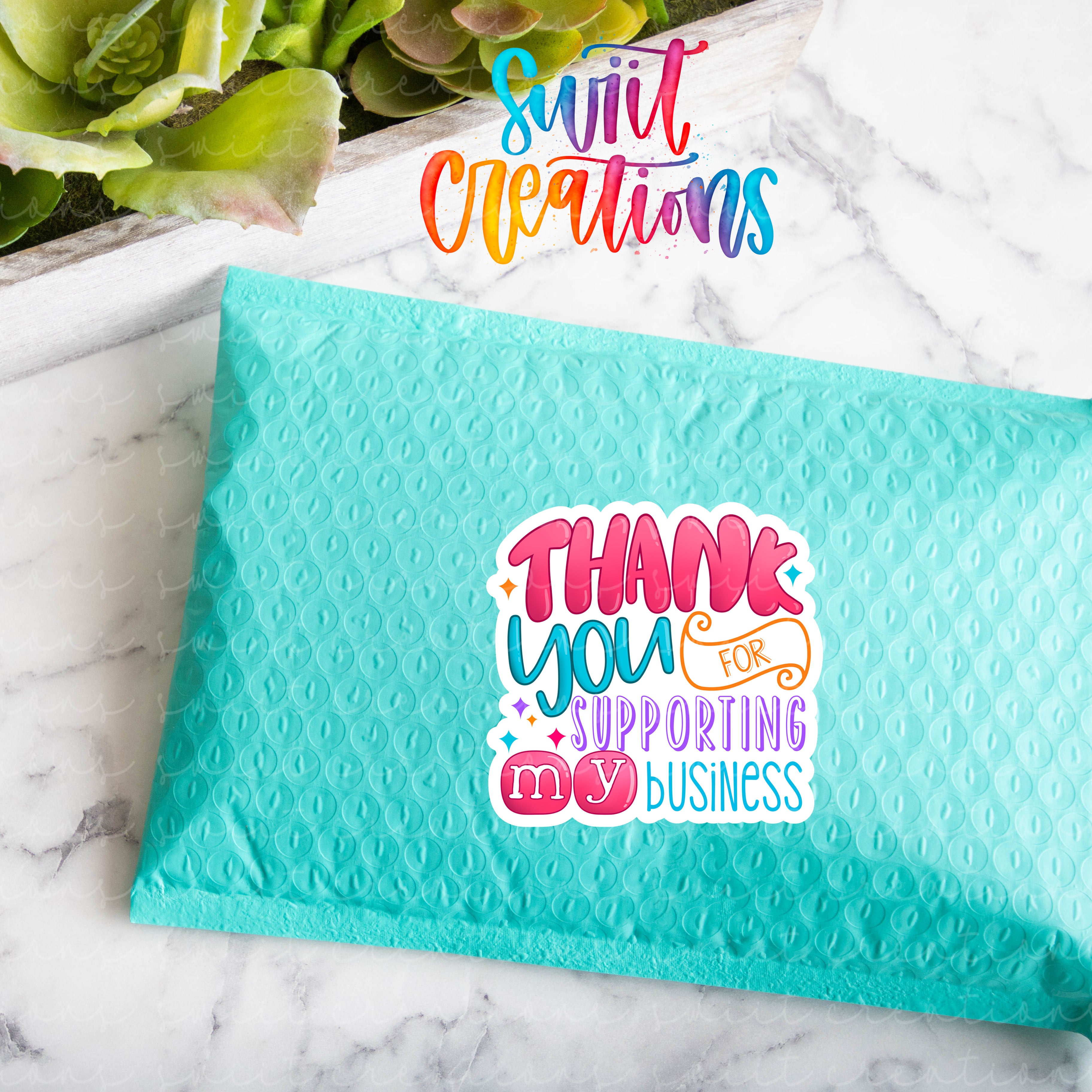 a blue envelope with a thank you wrapping sticker on it
