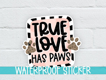 True Love Has Paws sticker on a white brick background with a waterproof sticker banner