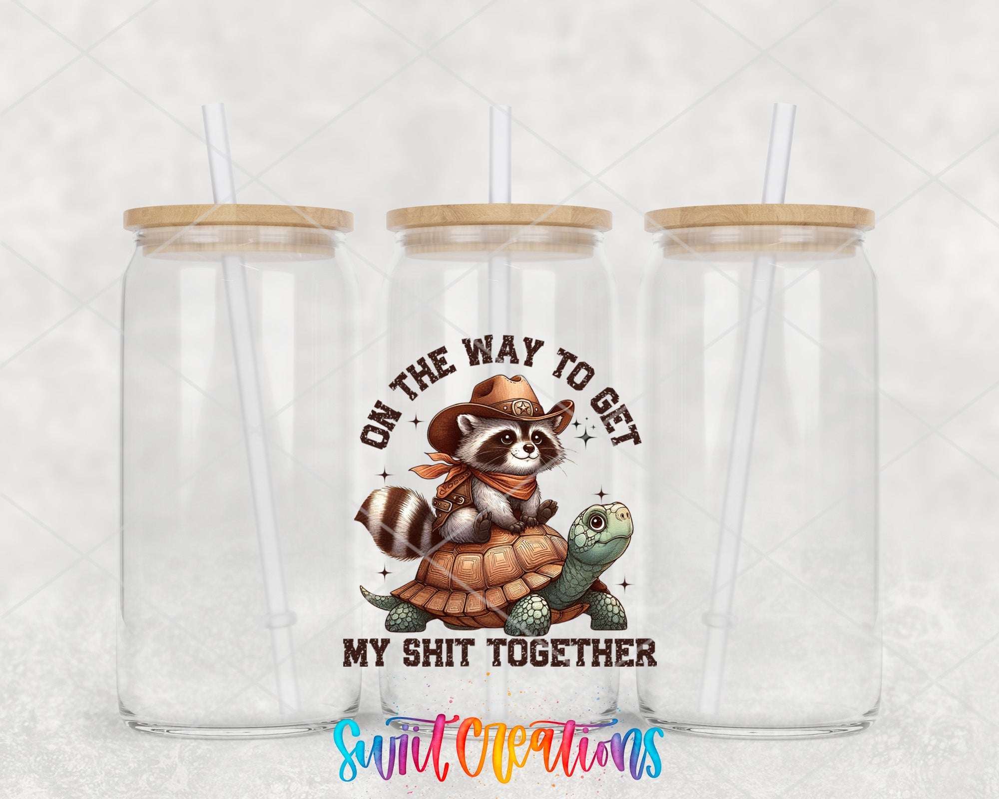 two clear tumblers with a raccoon and turtle on them