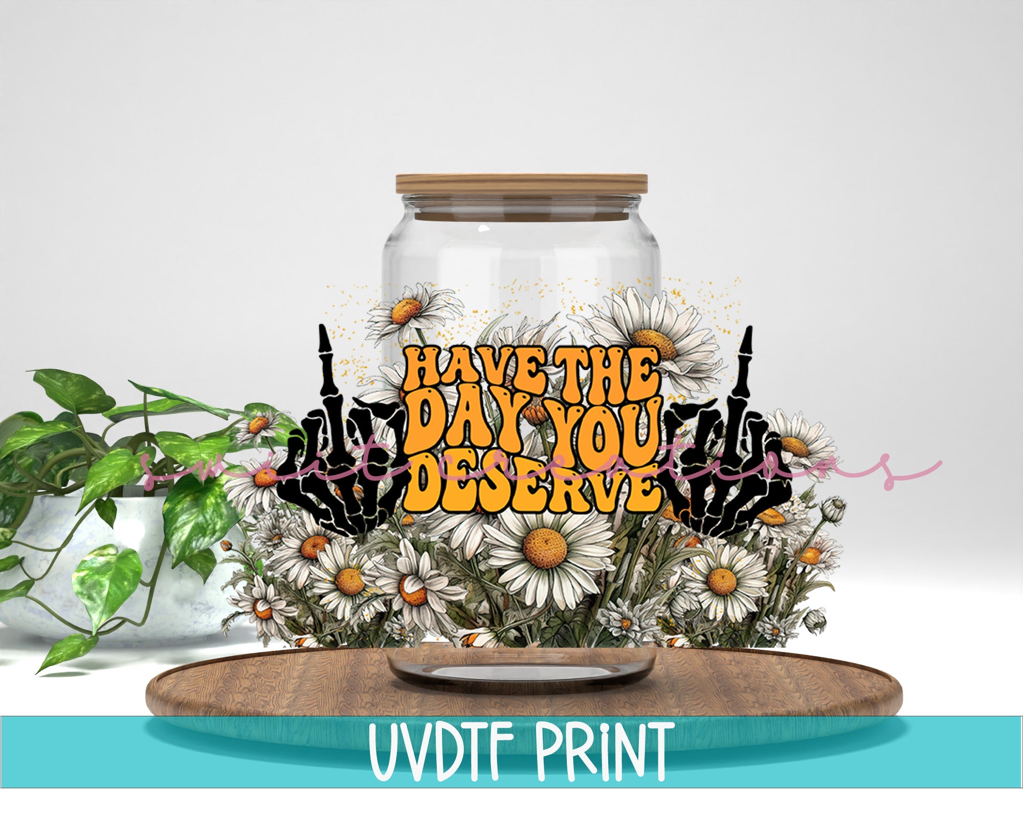 a jar with flowers and a sign that says have the day you deserves