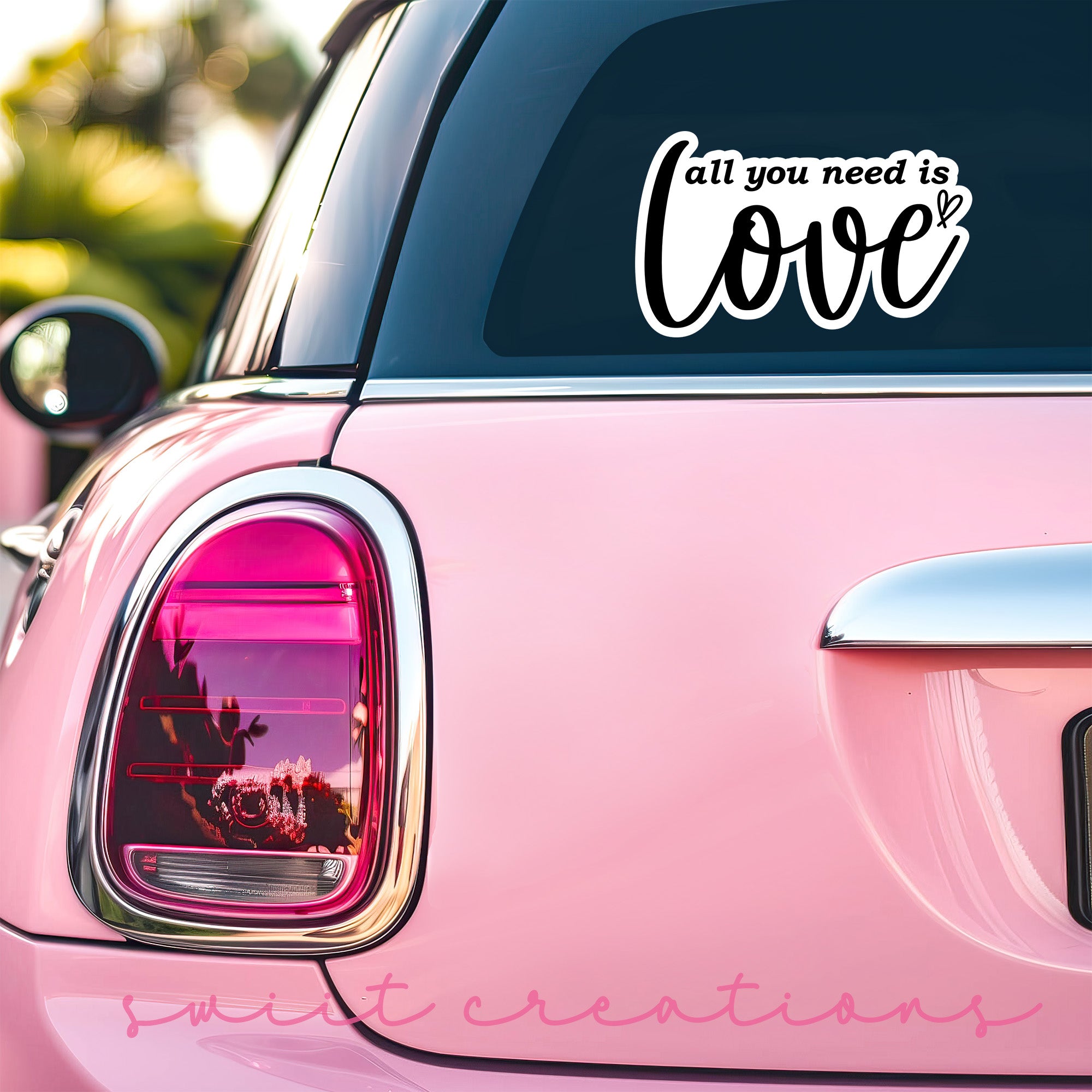 a pink car with a sticker that says, all you need is love