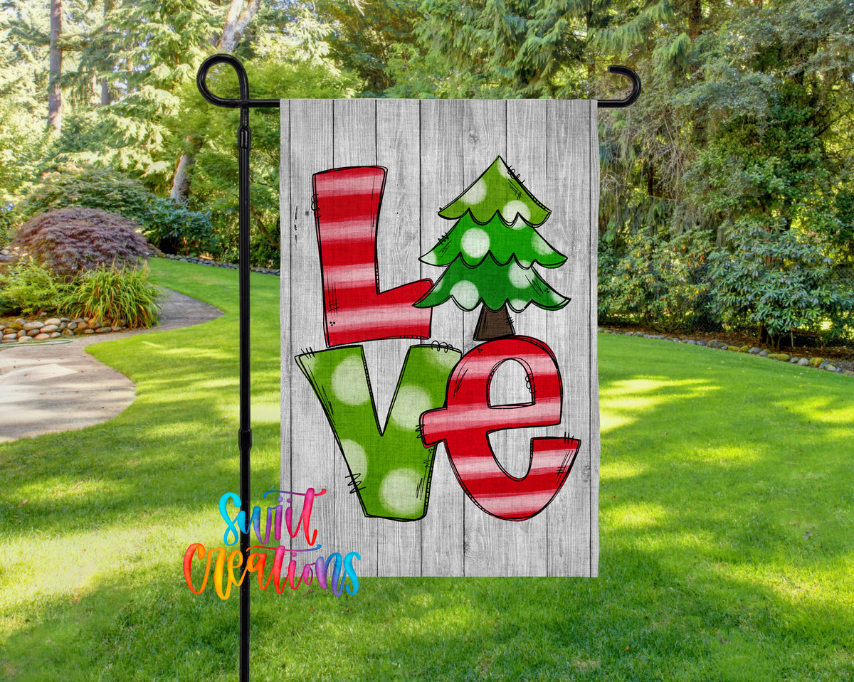 A flag with the word "LOVE" written on it, featuring a Christmas tree design.
