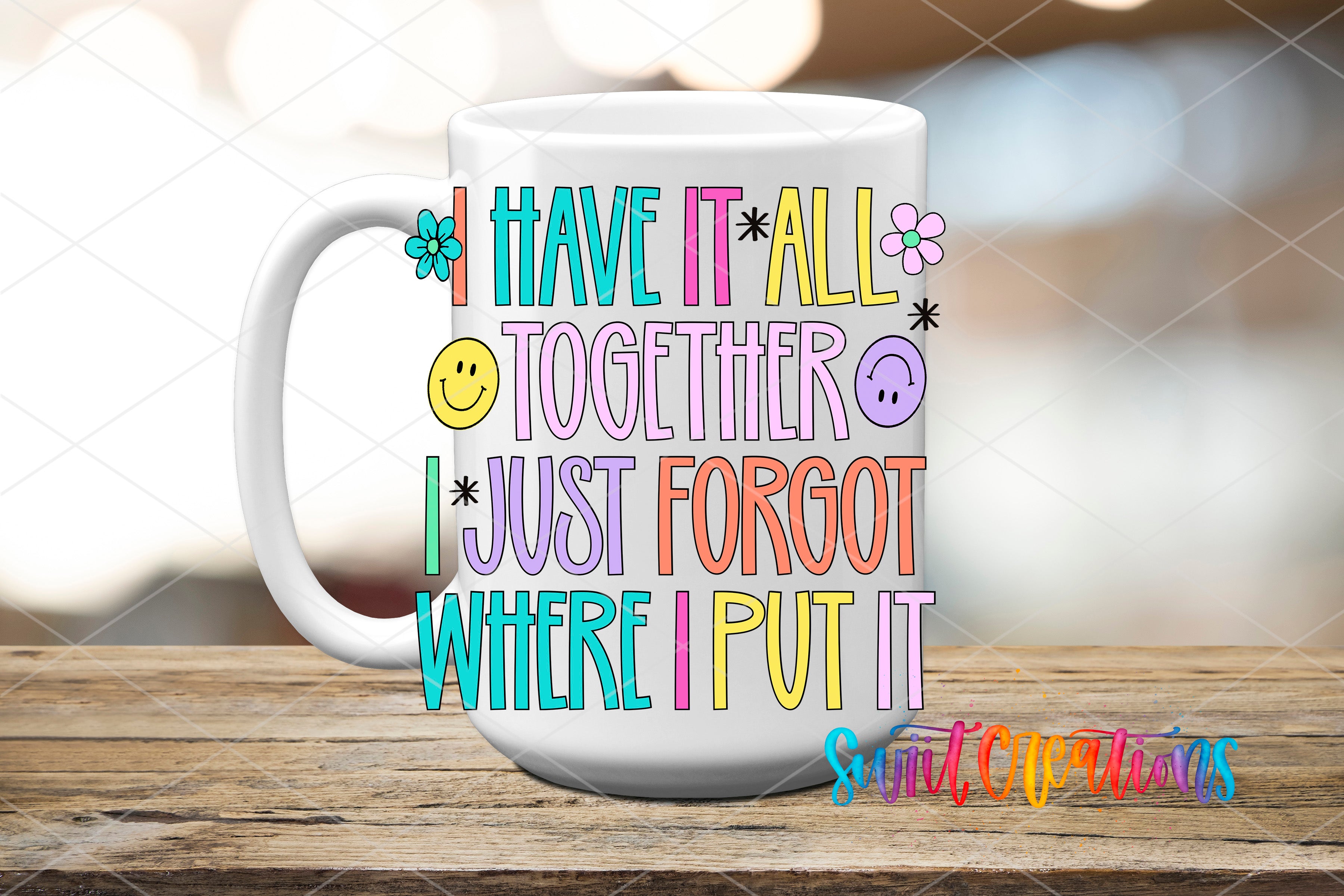 A white mug with colorful text and illustrations on it, placed on a wooden surface.