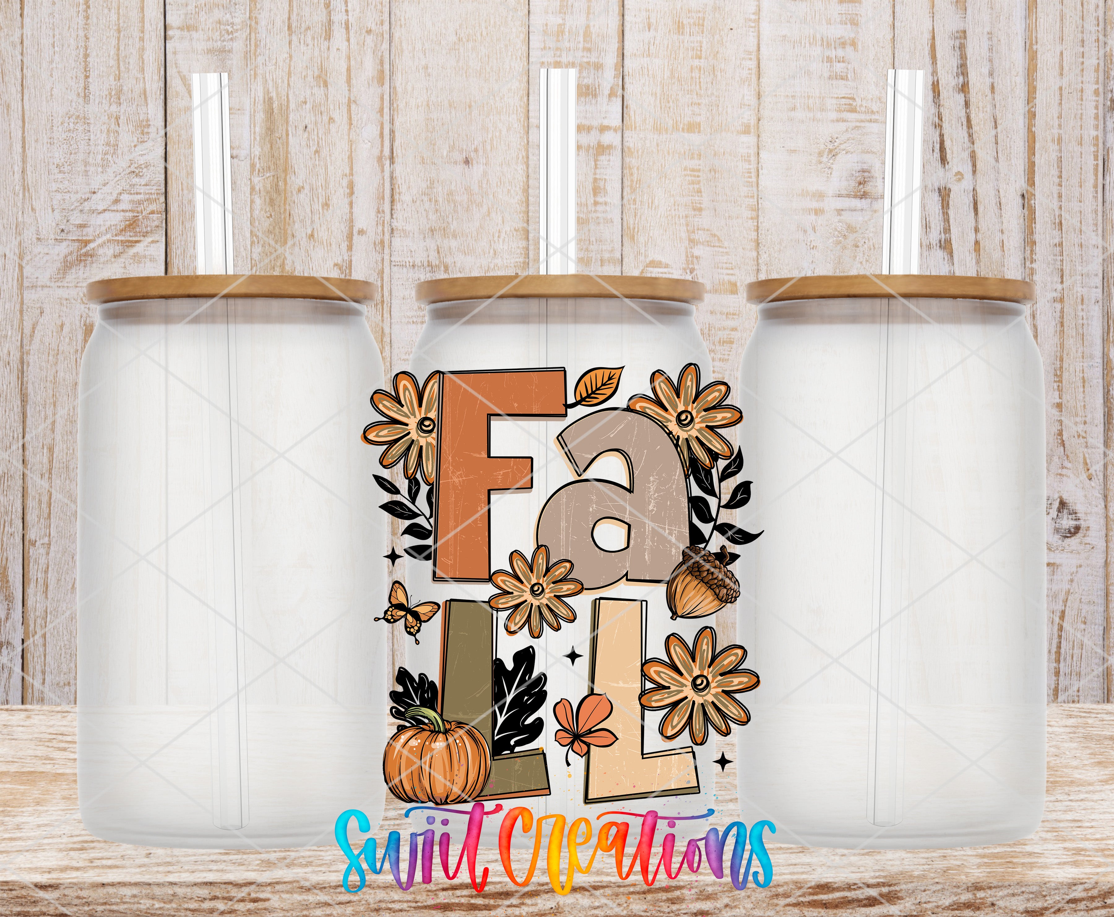 three glass jars with straws, each with a lid, arranged in a row against a wooden background. The jars are empty, and there is a colorful design on the front of one of them that includes the word "fall" and various fall-themed elements such as flowers, leaves, and acorns.