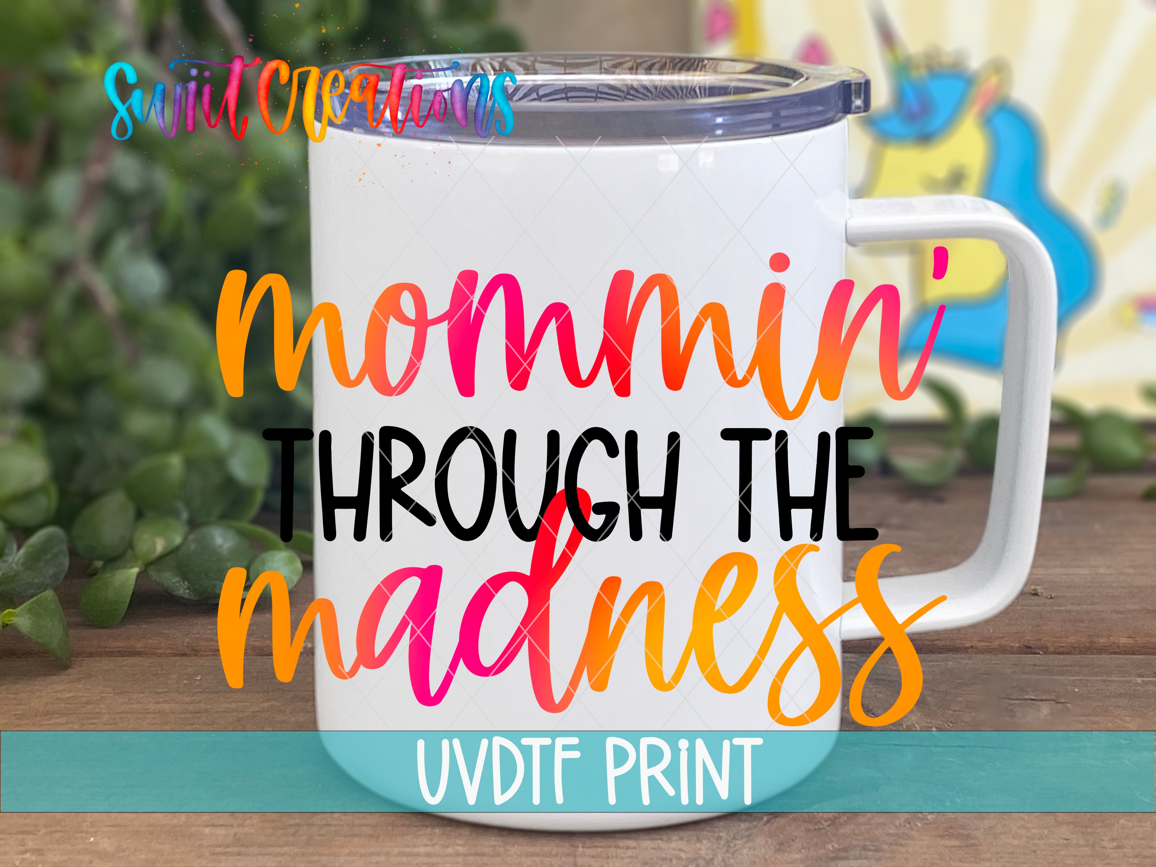 a white coffee mug with the words mommy through the madness on it