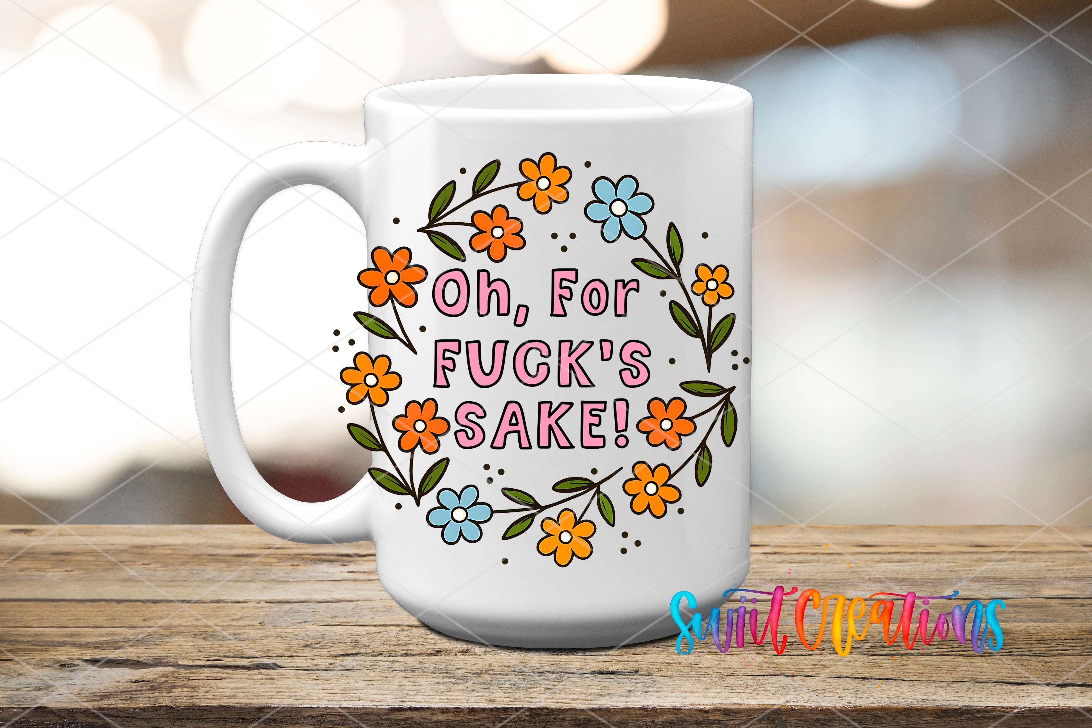 A white ceramic mug with a colorful floral design and text on it, placed on a wooden surface.