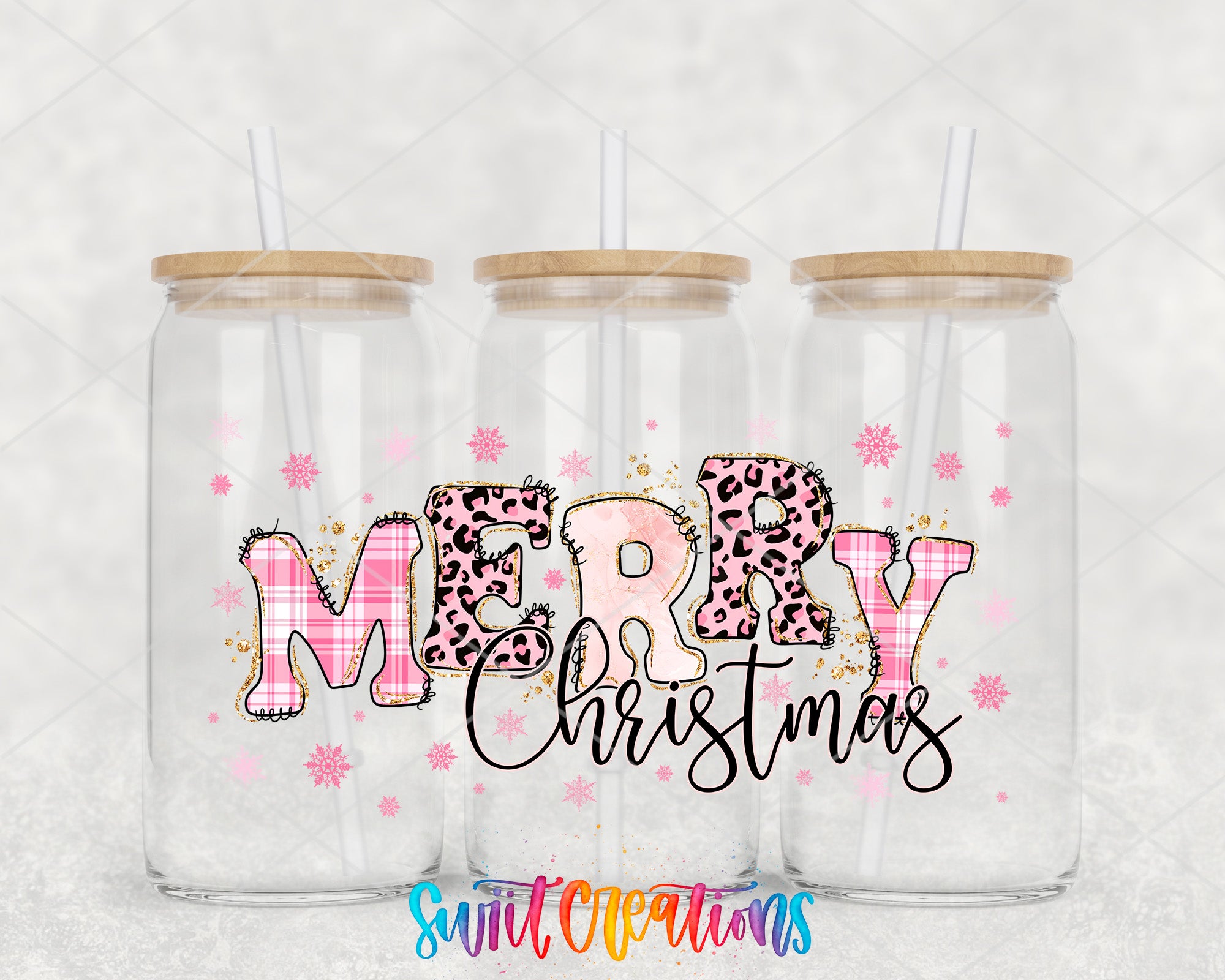 three clear glass jars with wooden lids, each containing a straw. The jars are decorated with a pink and black leopard print design and the text "MERRY CHRISTMAS" written in a stylized font.