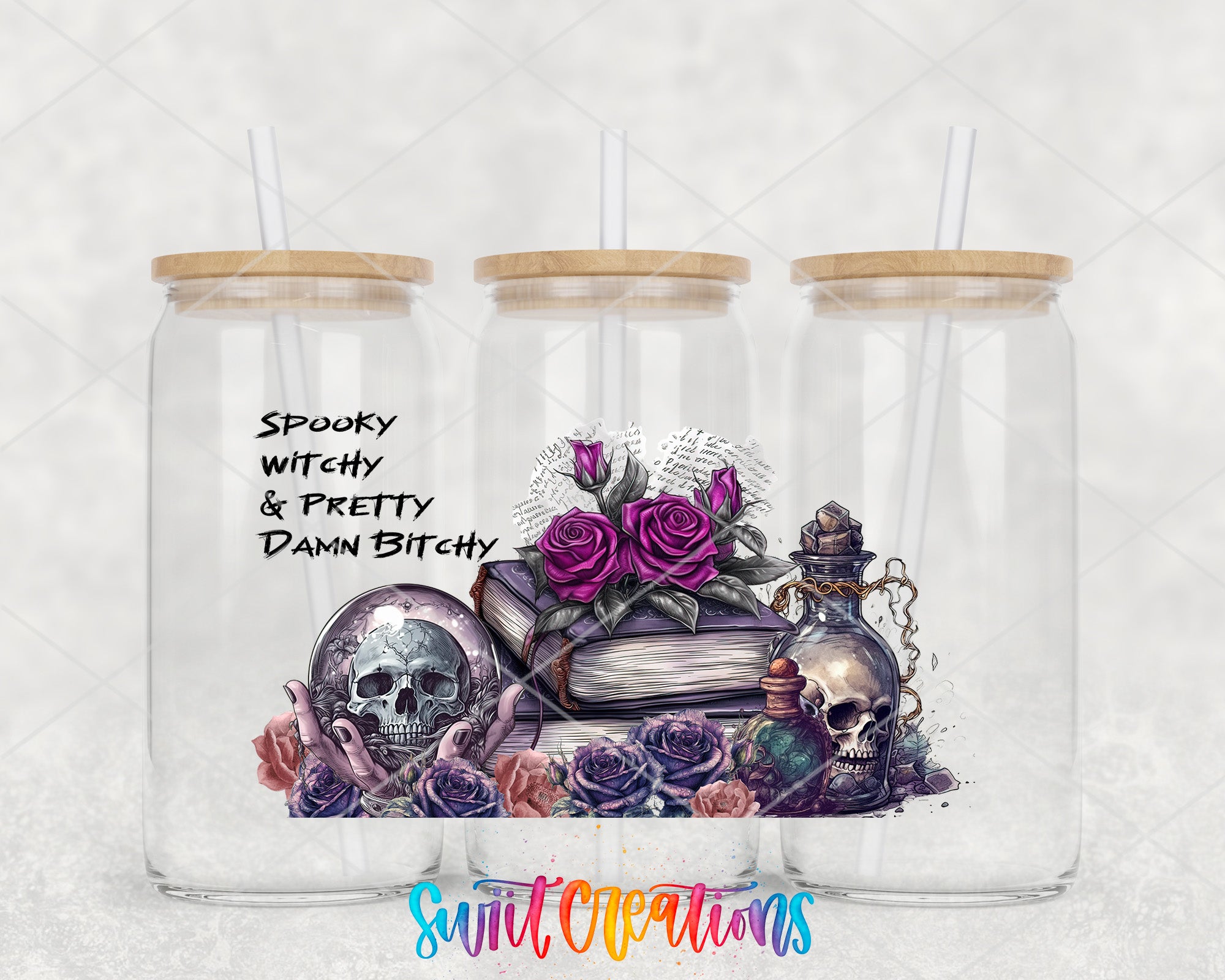 A trio of glass tumblers with wooden lids, each containing a unique illustration. The central illustration features a skull surrounded by flowers and a book, with the text "Spooky Witchy & Pretty Damn Bitchy" written above it.