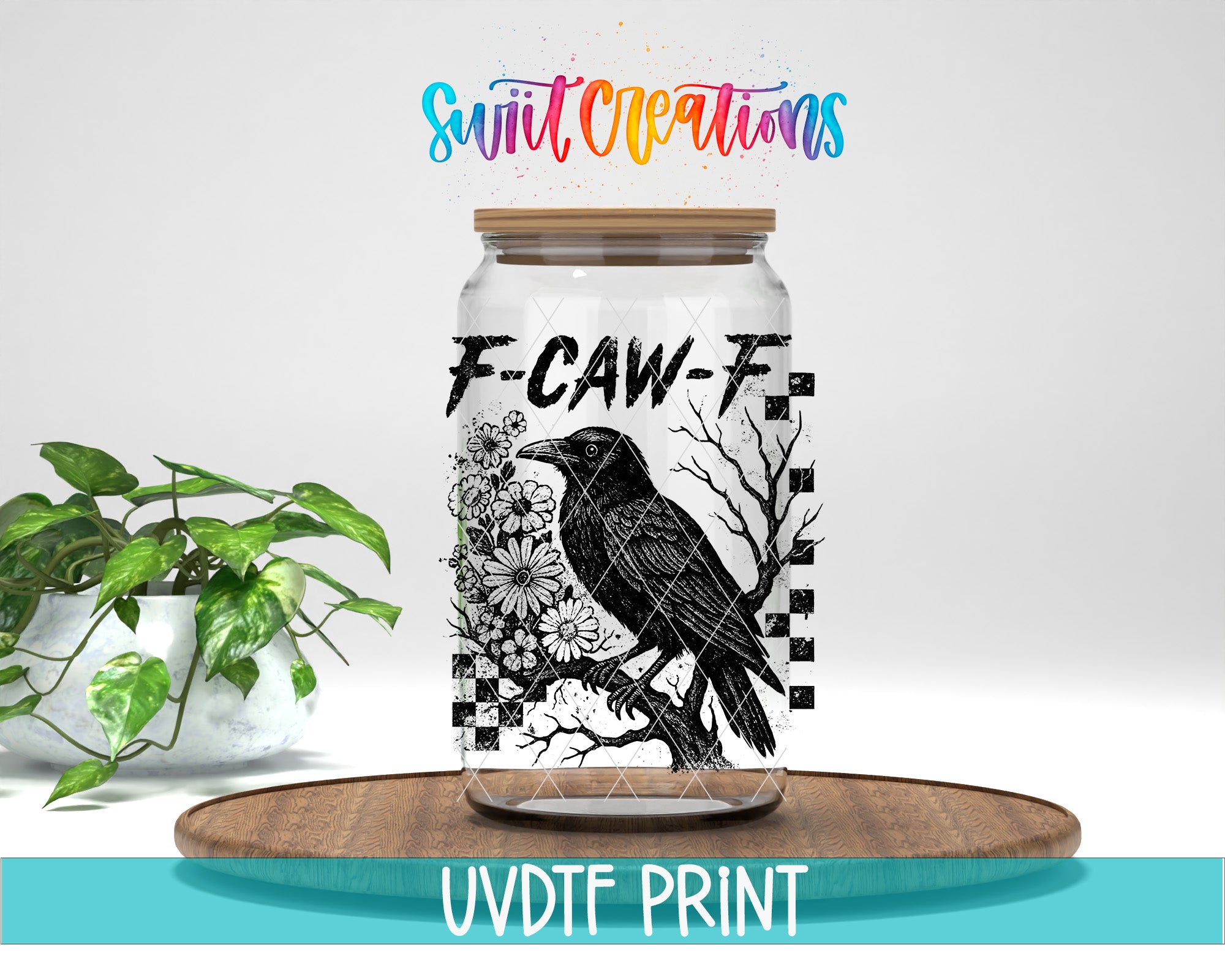 a glass jar with a black and white illustration of a bird, along with the text "F-CAW-F" and "Swift Creations" written above it. The jar is placed on a wooden surface, and there is a potted plant in the background.
