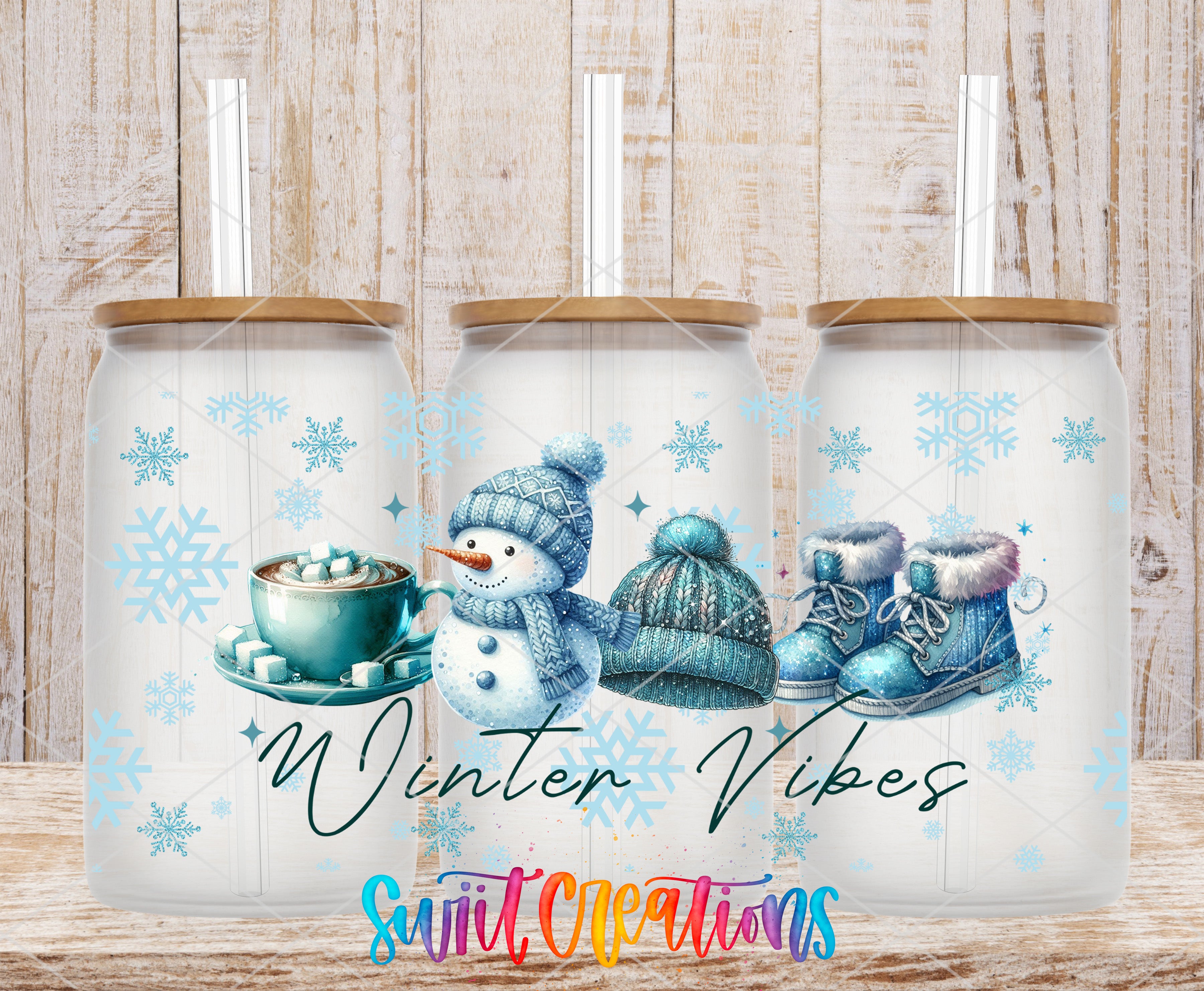 A set of three glass tumblers with winter-themed illustrations on them, including a snowman, a cup of hot chocolate, and a pair of boots.