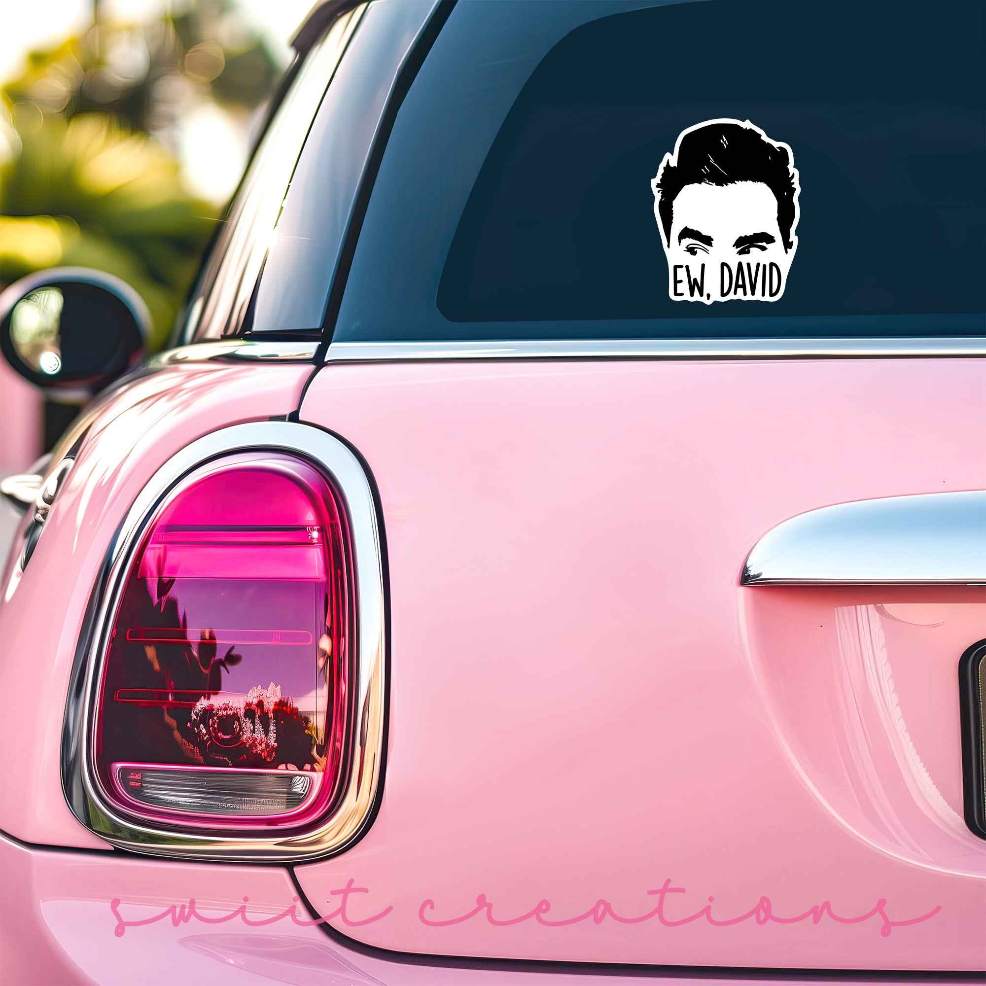 a pink car with a sticker of a man's face