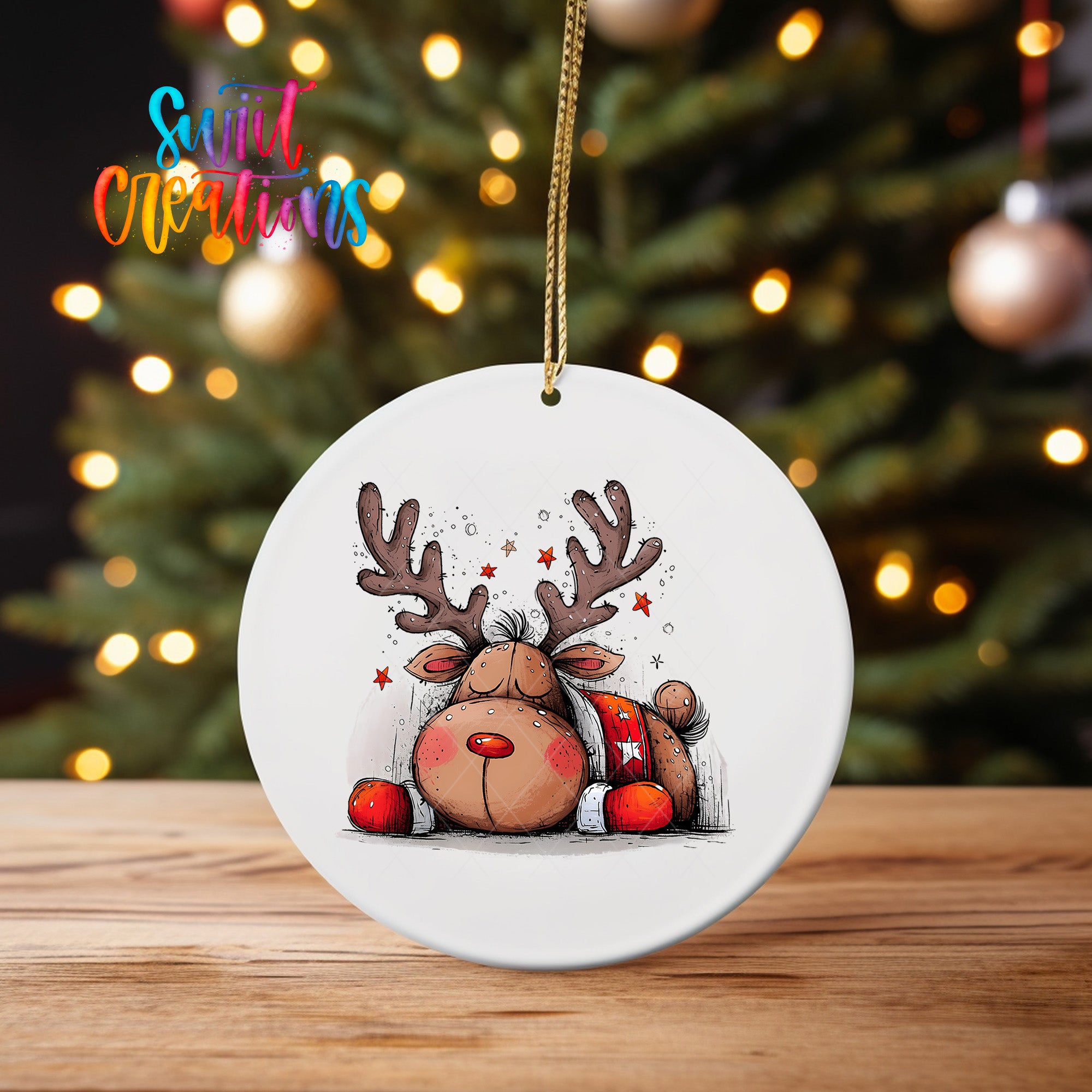 A white ceramic ornament featuring a cartoon reindeer with antlers and a starry background, hanging on a string.