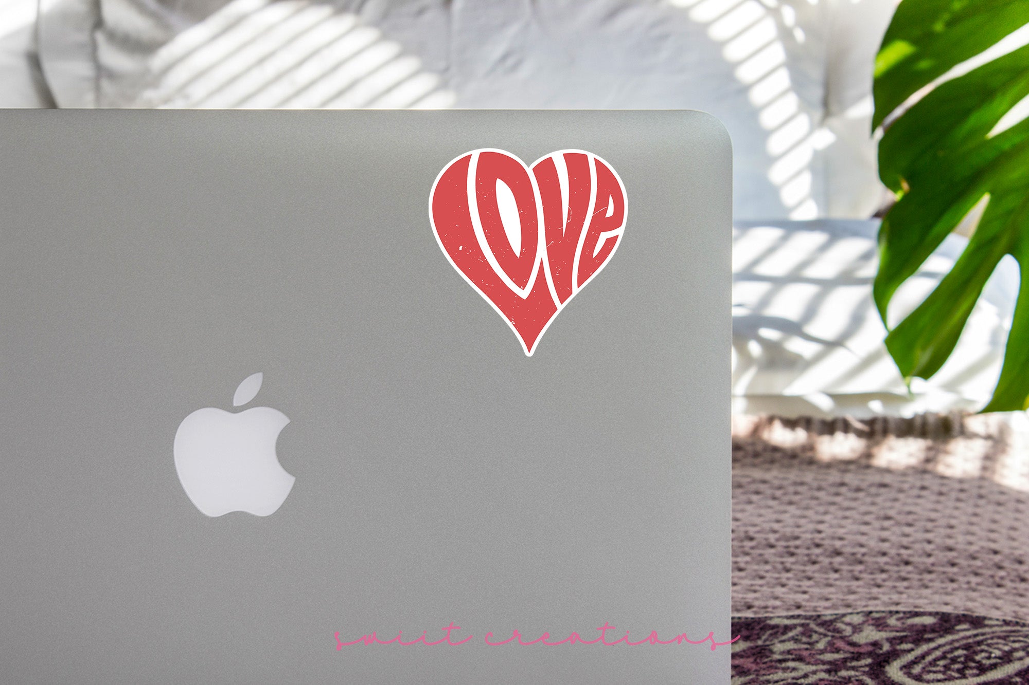 a laptop with a sticker of the word love on it