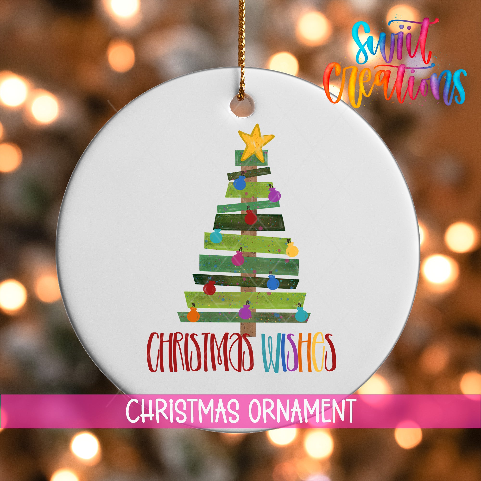 A white Christmas ornament with a colorful tree design and the text "Christmas Wishes" written on it.