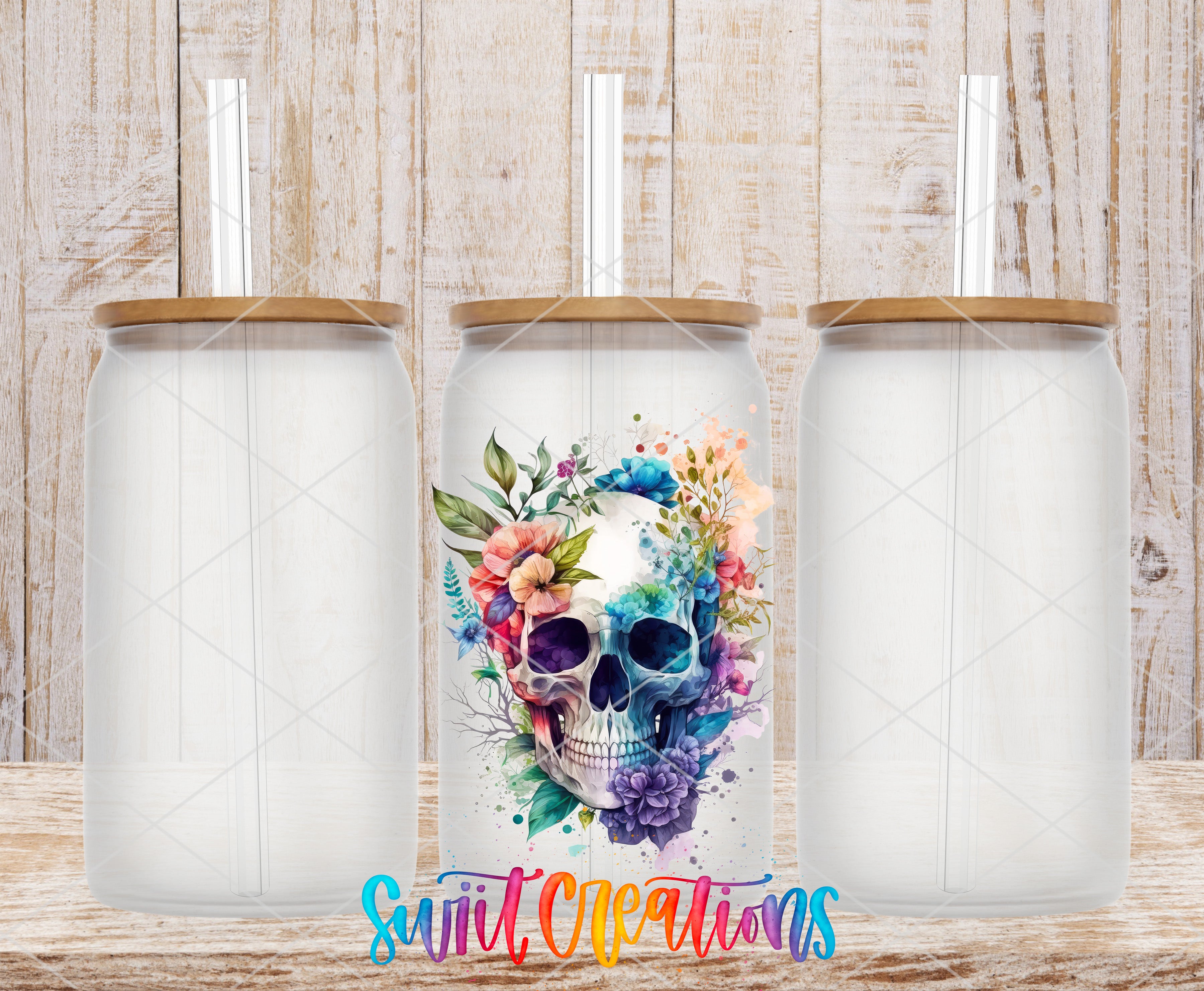 three glass jars with a colorful floral design on the front, placed on a wooden surface.