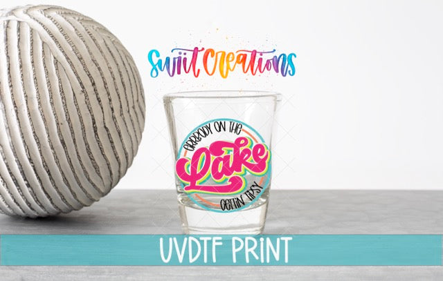 a ball of yarn next to a glass of water