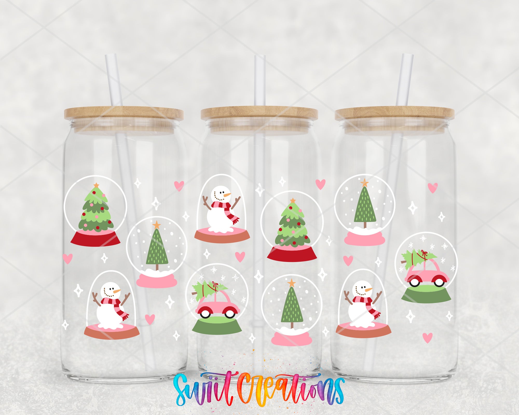 a set of four snow globes with snowmen and christmas trees