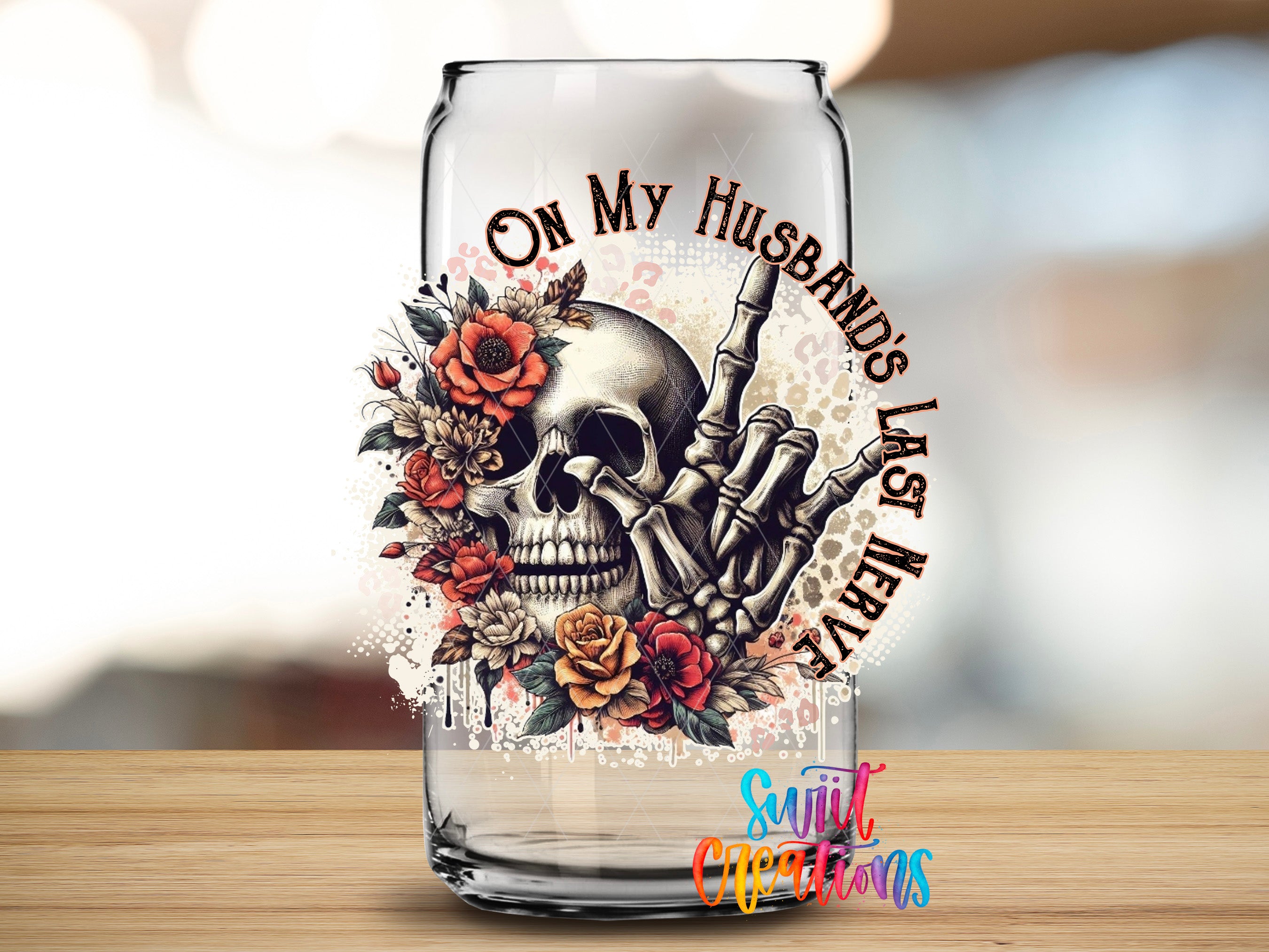a glass can with a skull and floral design on it, along with the text "On My Husband's Last Night" written around the skull.