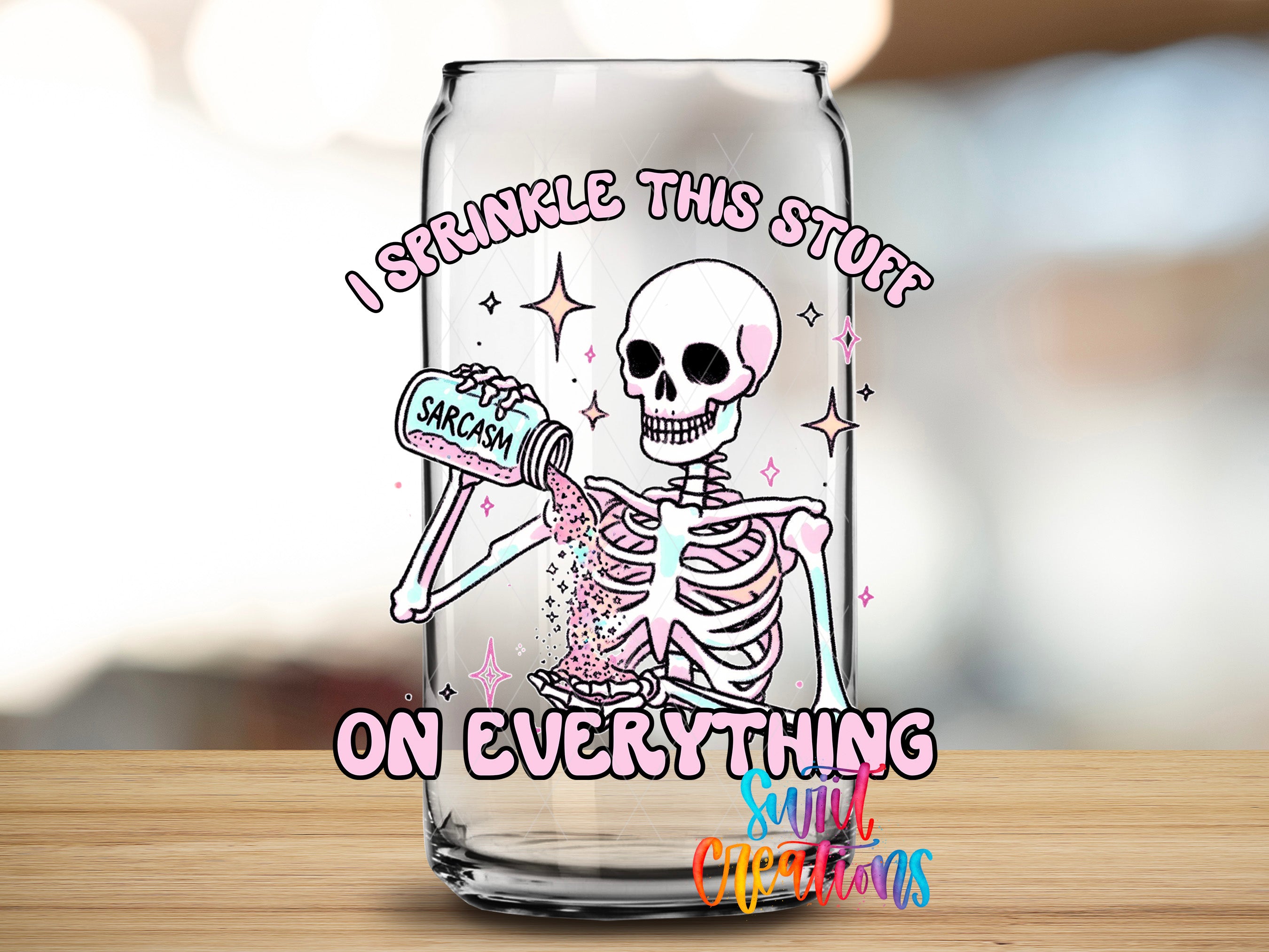 A glass with a skeleton holding a can labeled "Sarcasm" and the text "I sprinkle this stuff on everything" written on it.