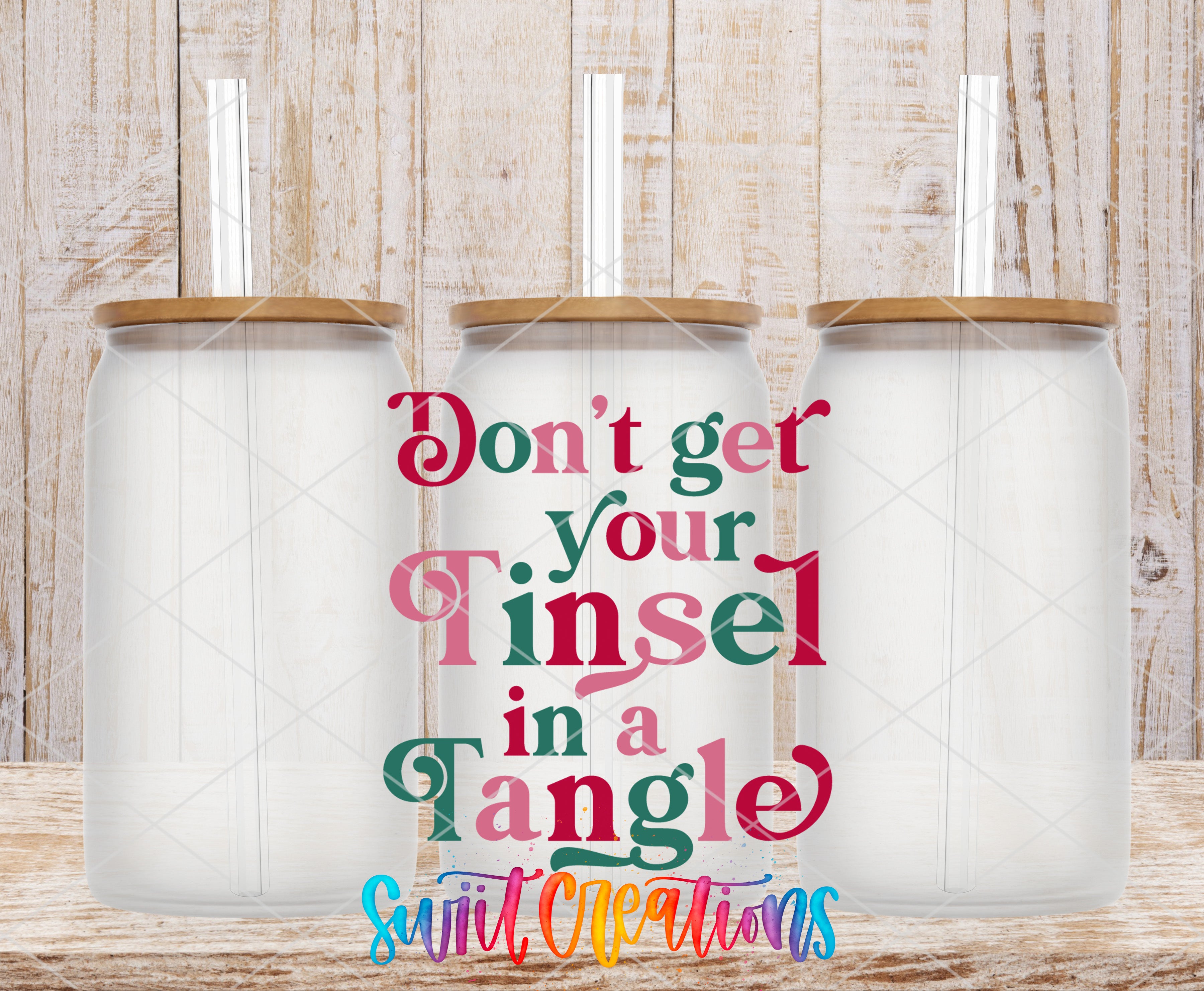 three glass jars with lids, arranged in a row against a wooden background. The text overlay on the image reads "Don't get your tinsel in a tangle" in a colorful, stylized font.