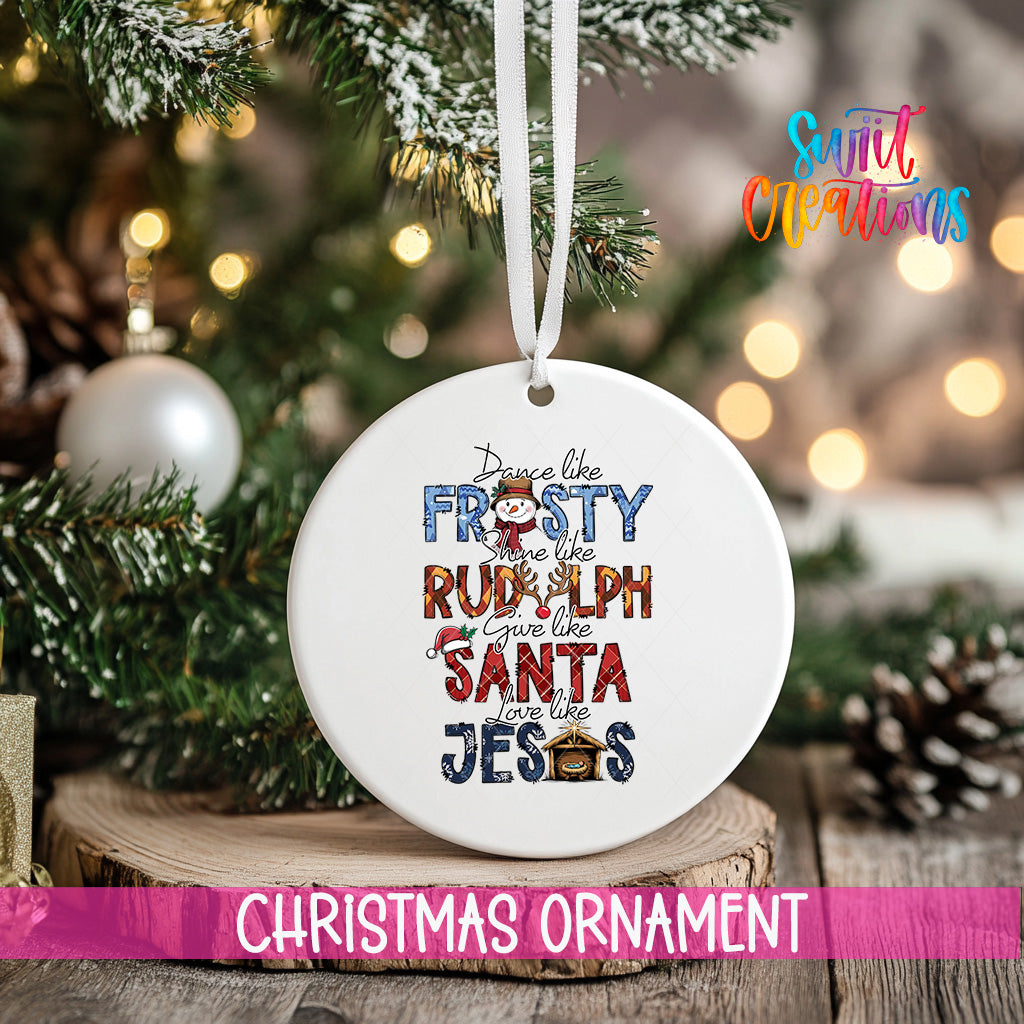 A white Christmas ornament with text that says "Dance like the FROSTY RUMPH gives like a RULPH like a SANTA like JESUS" is hanging on a Christmas tree.