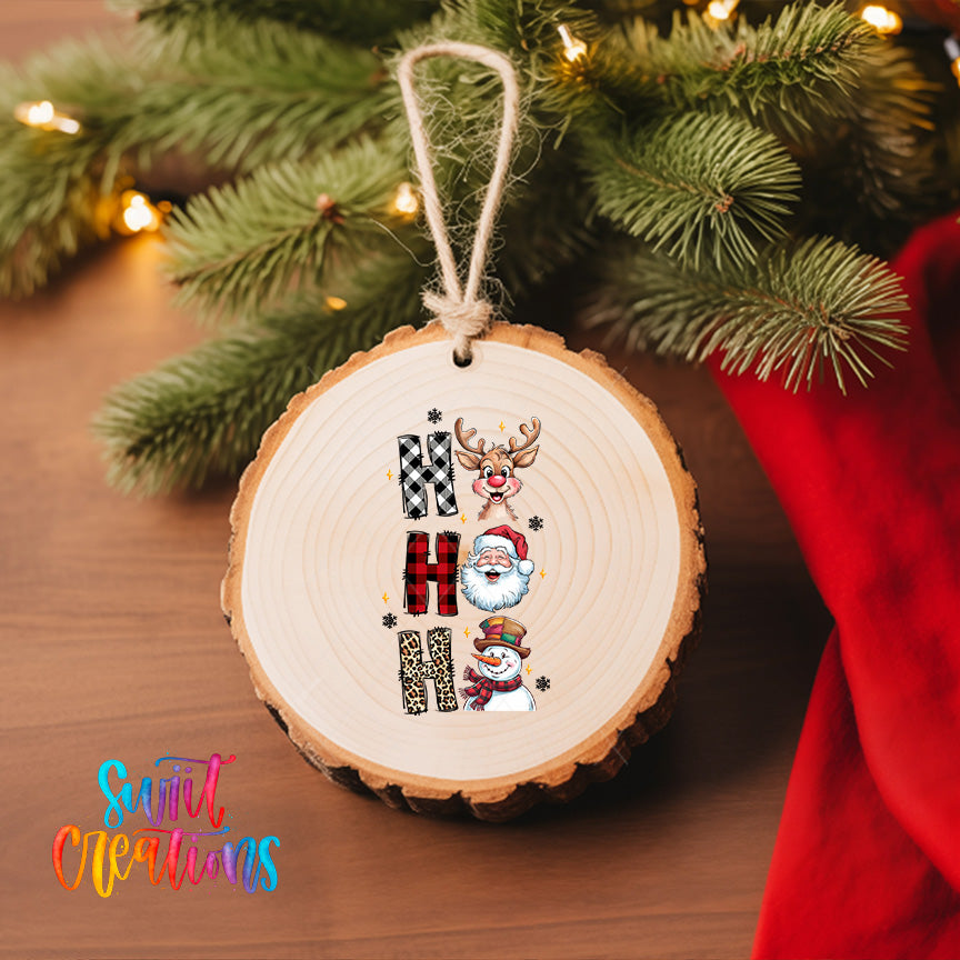 A wooden ornament with a Christmas tree in the background.