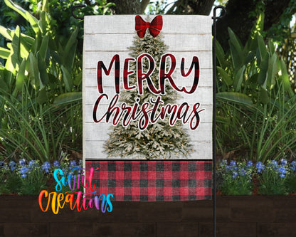 A white garden sign with a Christmas tree design and the text "MERRY CHRISTMAS" displayed in a festive style.