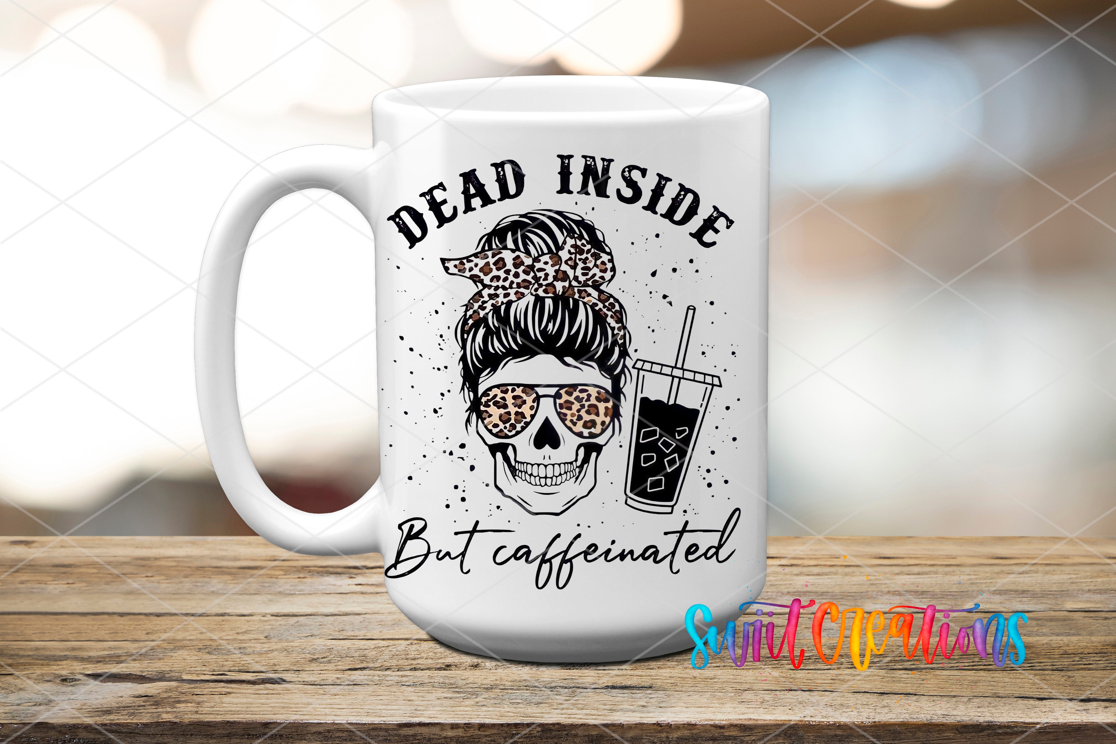 A white ceramic mug with a black and white skull design and the text "Dead inside but caffeinated" printed on it.