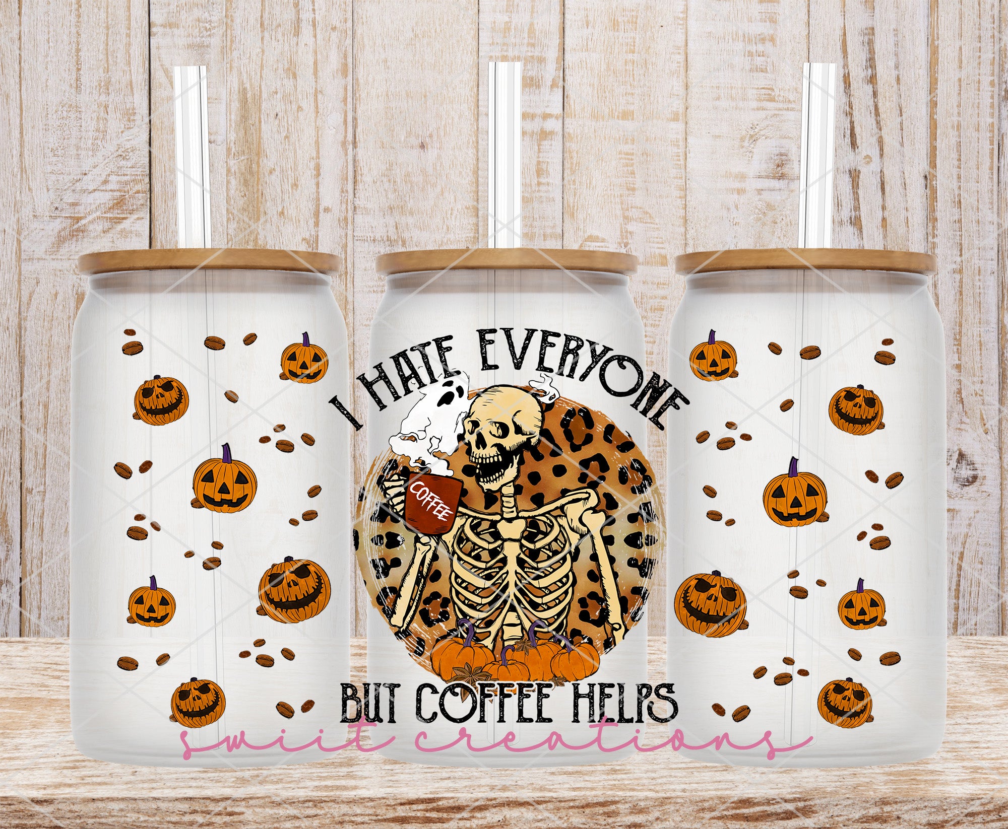 two coffee mugs decorated with skeletons and pumpkins