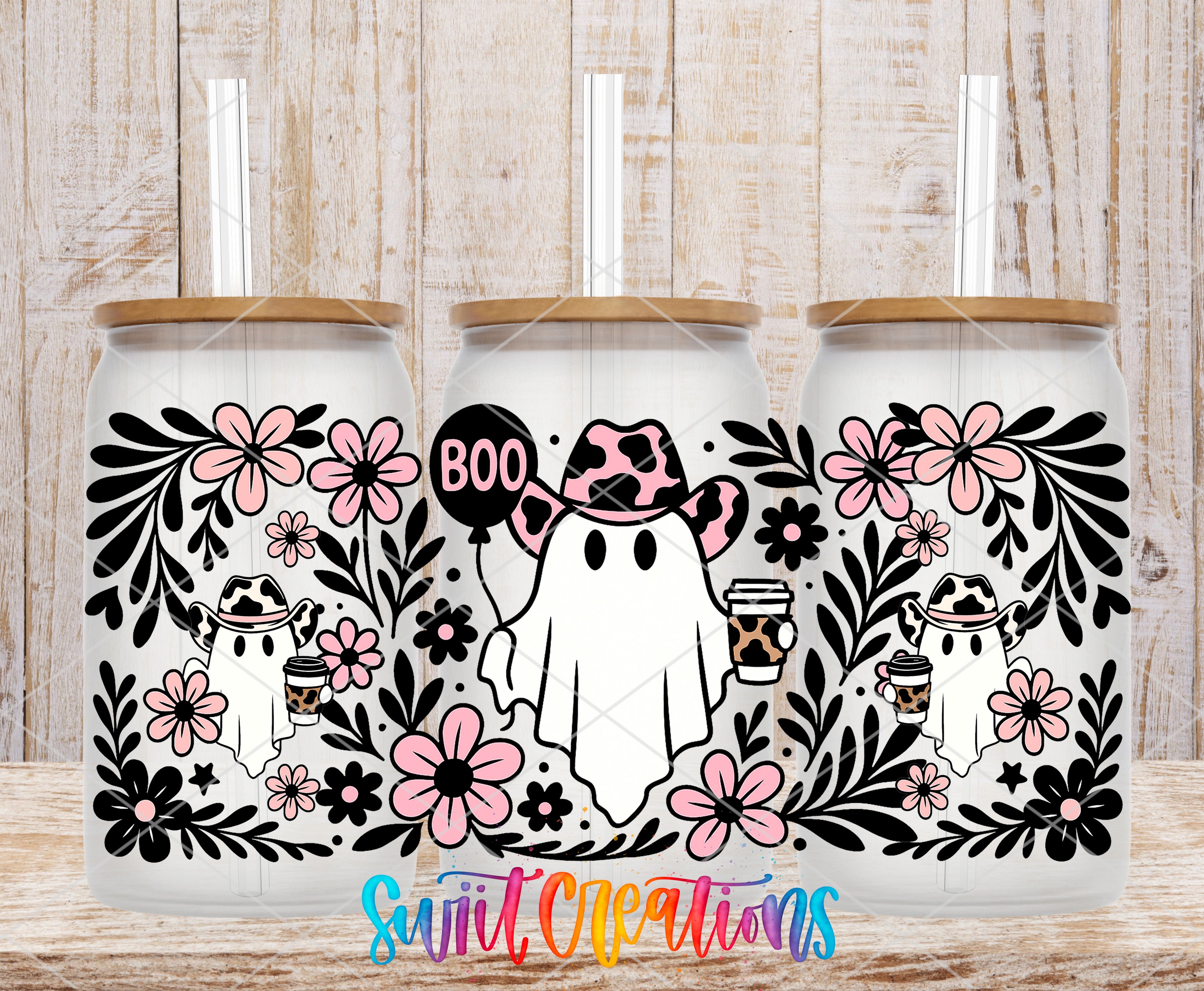 three white tumblers with black floral designs and pink flowers. Each tumbler has a straw and a small ghost character wearing a cowboy hat. The text "Boo" is displayed on the tumbler.