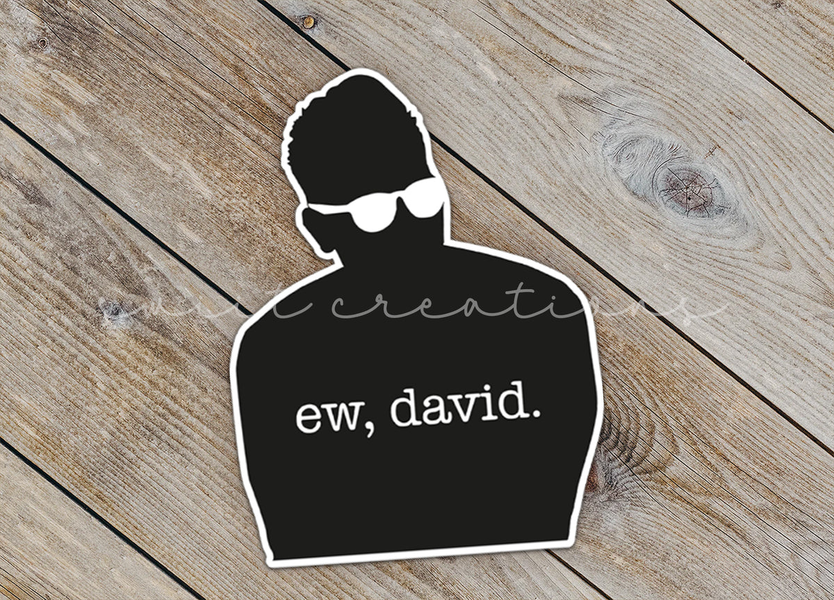 Close-up of the Ew David Silhouette sticker on rustic wood