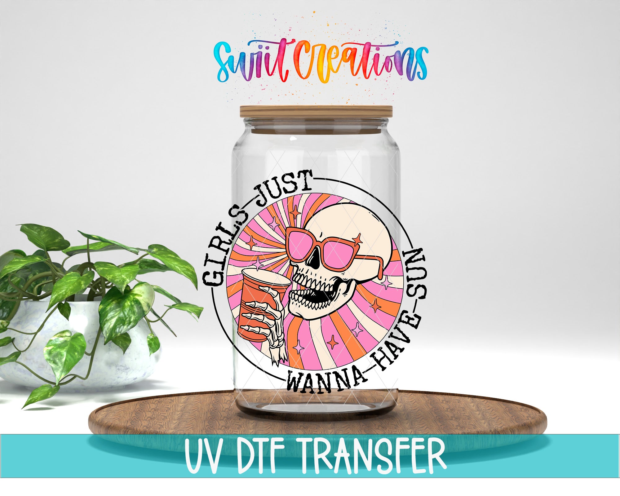 A glass jar with a skull wearing sunglasses and the text "GIRLS JUST WANNA HAVE SUN" printed on it, placed on a wooden surface.