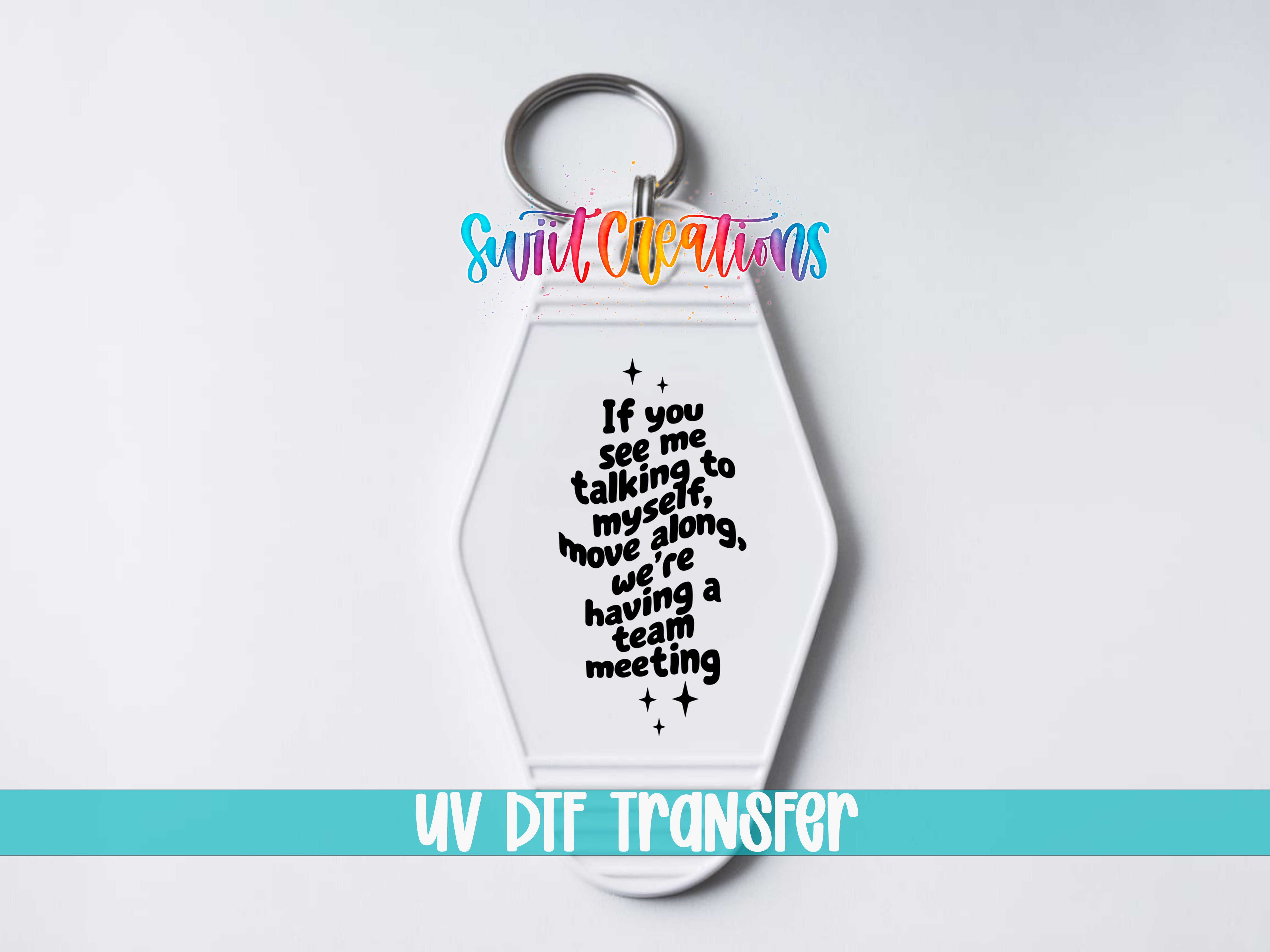 A keychain with a message printed on it, which says "If you see me talking to myself along, we're having a team meeting".