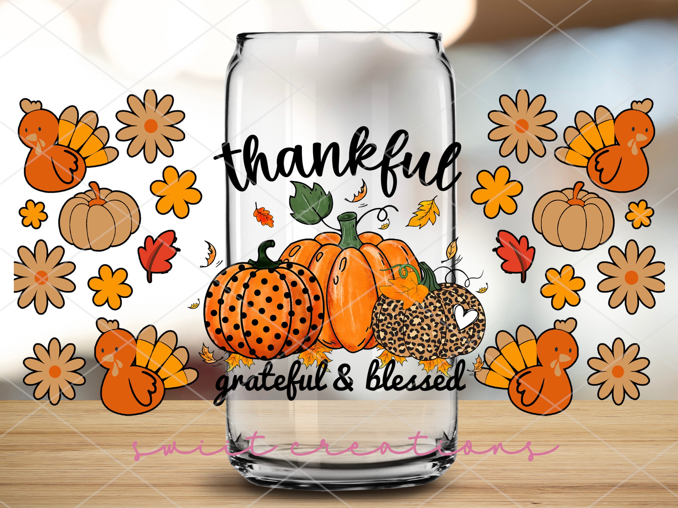 a glass of milk with a picture of pumpkins on it
