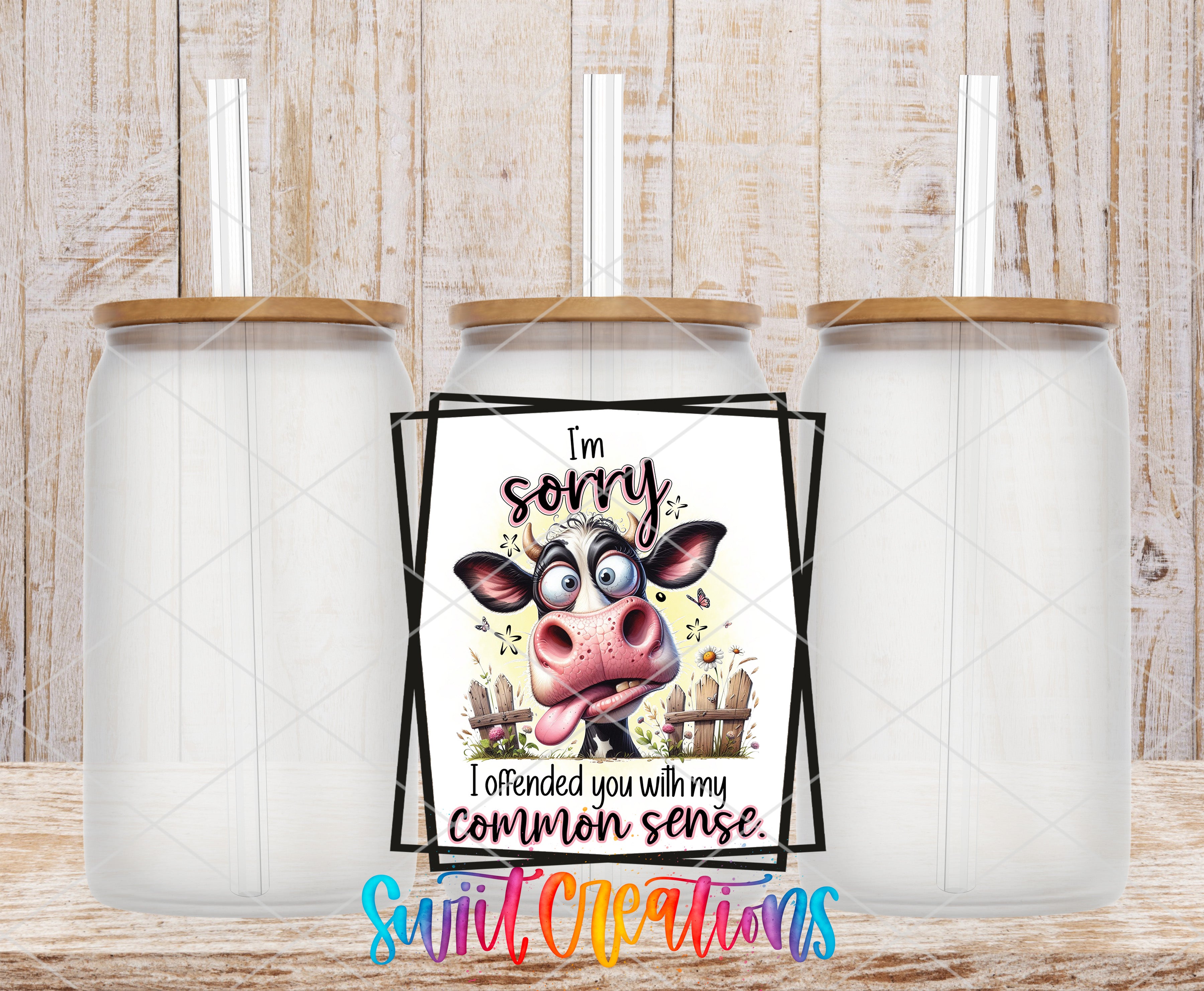 a humorous sign with a cow's face and the text "I'm sorry, I attended you with my common sense." The sign is placed between two transparent glass jars, creating a playful and lighthearted atmosphere.