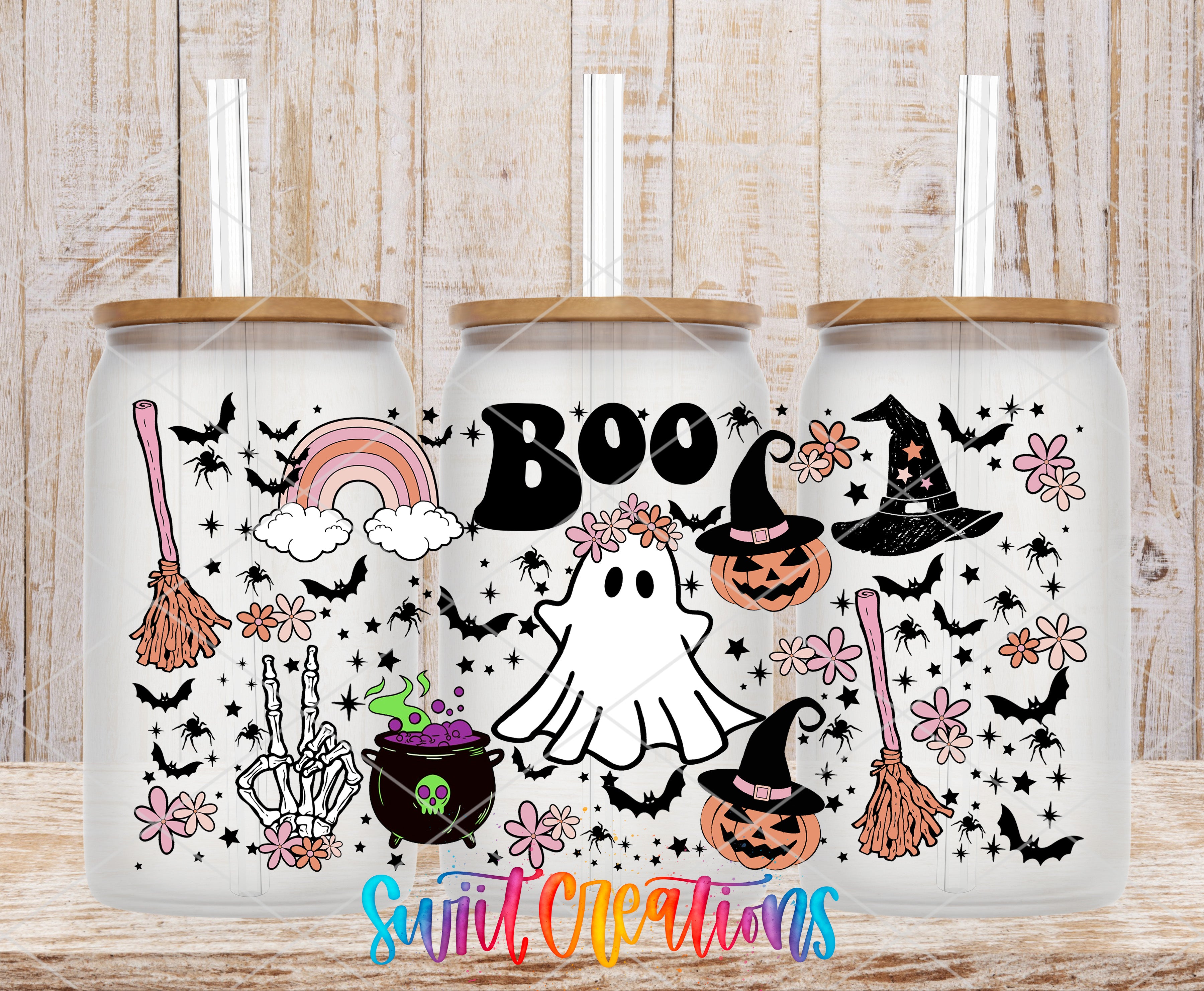A collection of Halloween-themed items, including a ghost, witch's hat, broomstick, pumpkin, spider, and flowers, arranged on a wooden surface.