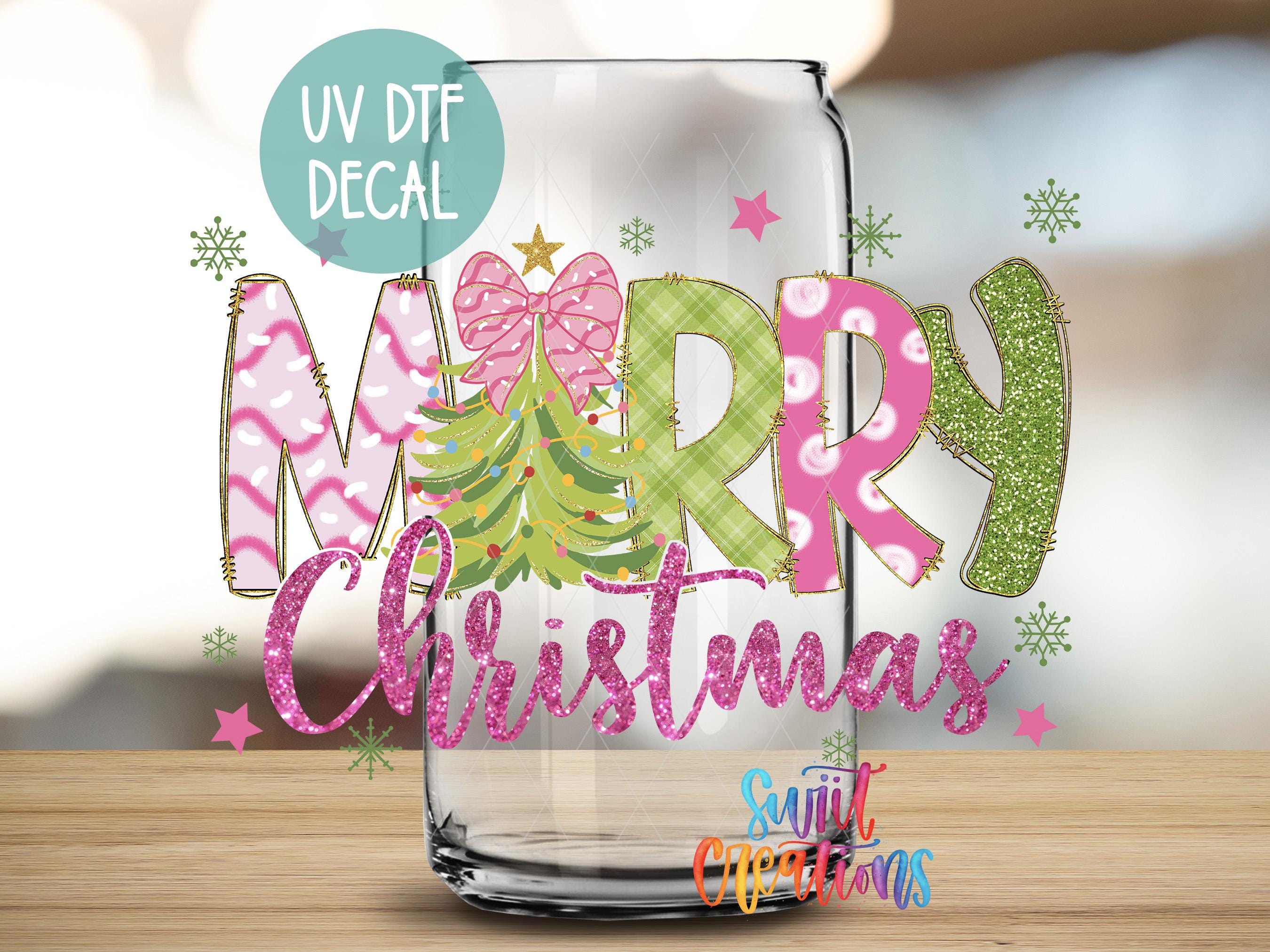 a glass jar with a festive Christmas-themed design, including the text "Merry Christmas" and various decorative elements such as snowflakes and stars.