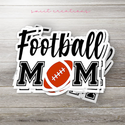 Stack of Football Mom glossy stickers on a gray wood table