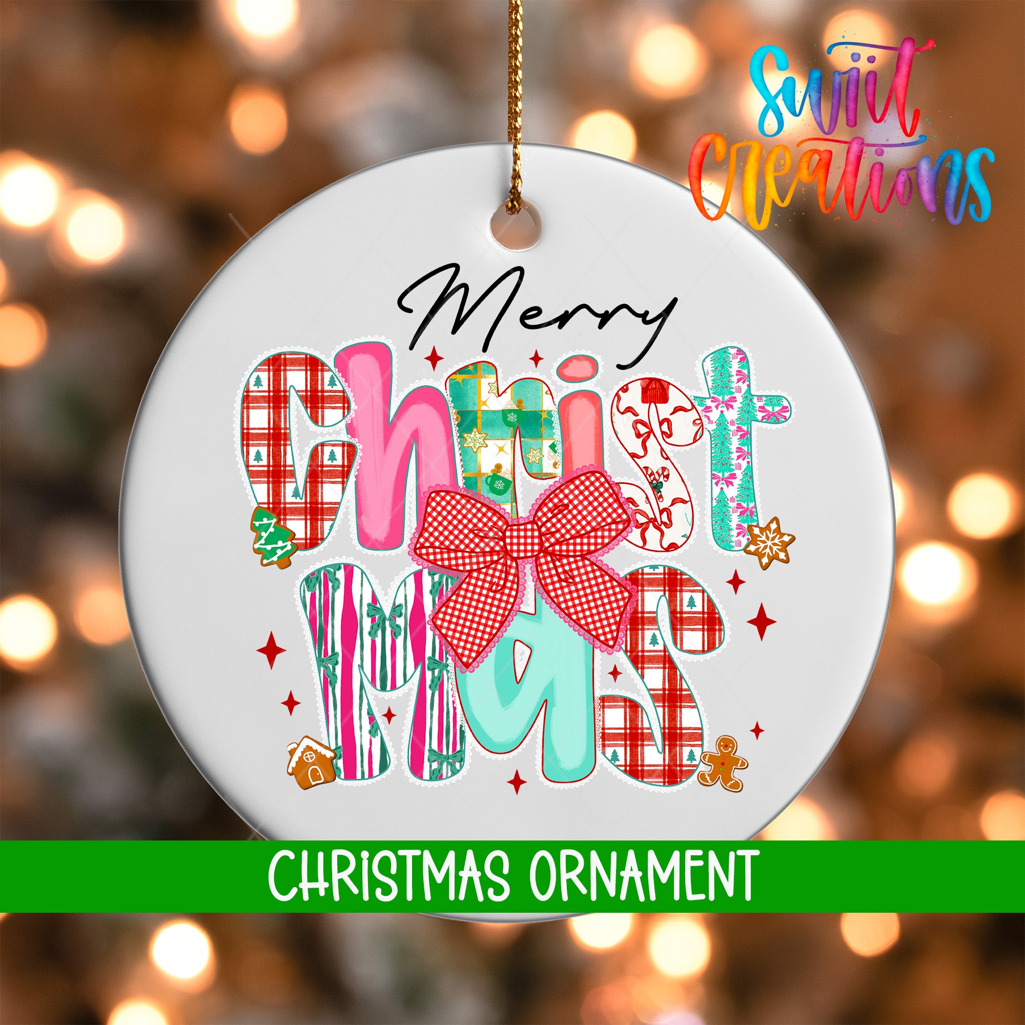 A white Christmas ornament with colorful text and decorations hanging against a blurred background with Christmas lights.