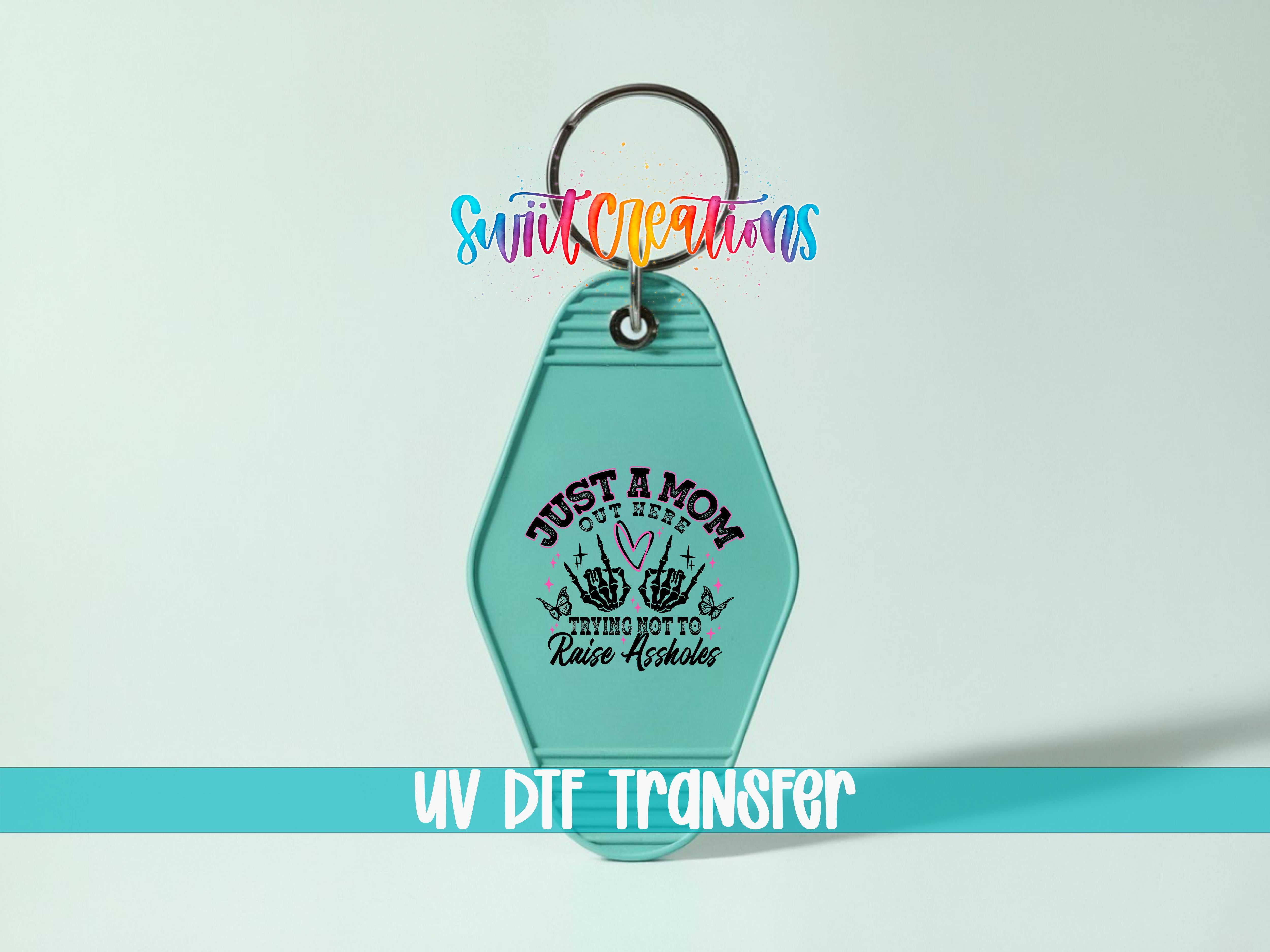A keychain with a message that says "Just a Mom, trying not to raise any hell" printed on it.