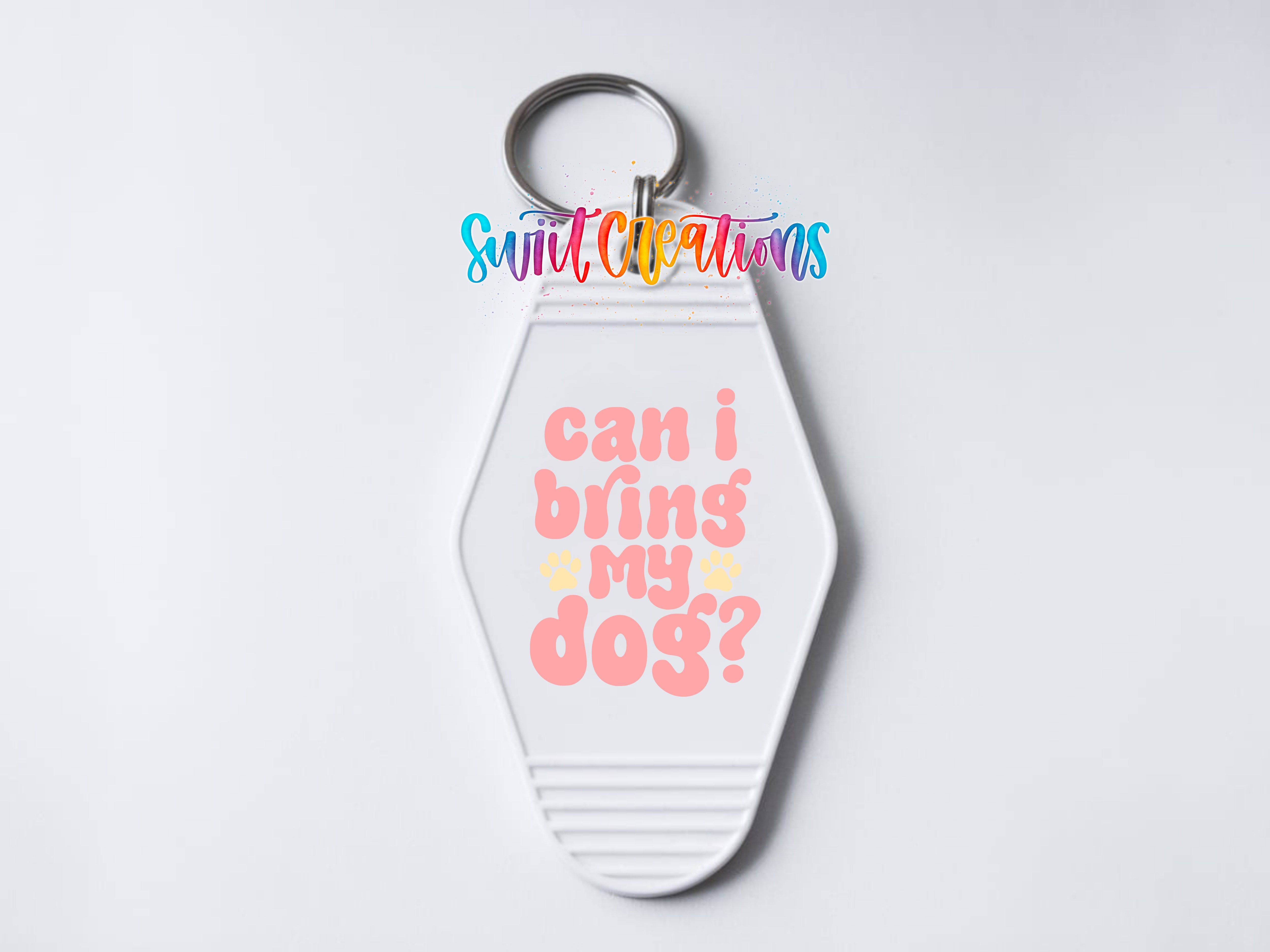 A keychain with a message printed on it, which says "Can I bring my dog?"