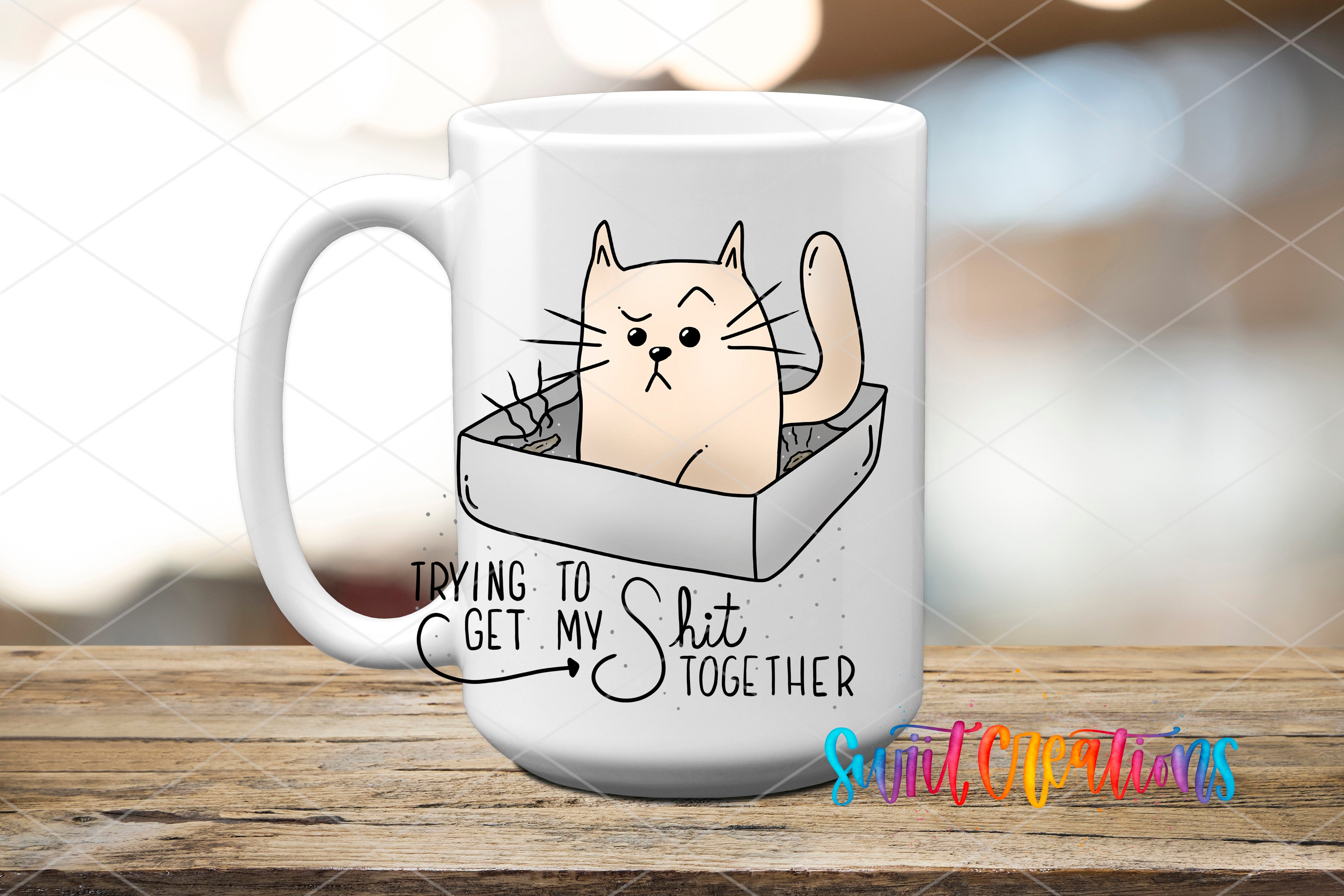 A white mug with a cartoon cat illustration and text that says "Trying to Get My Shit Together".