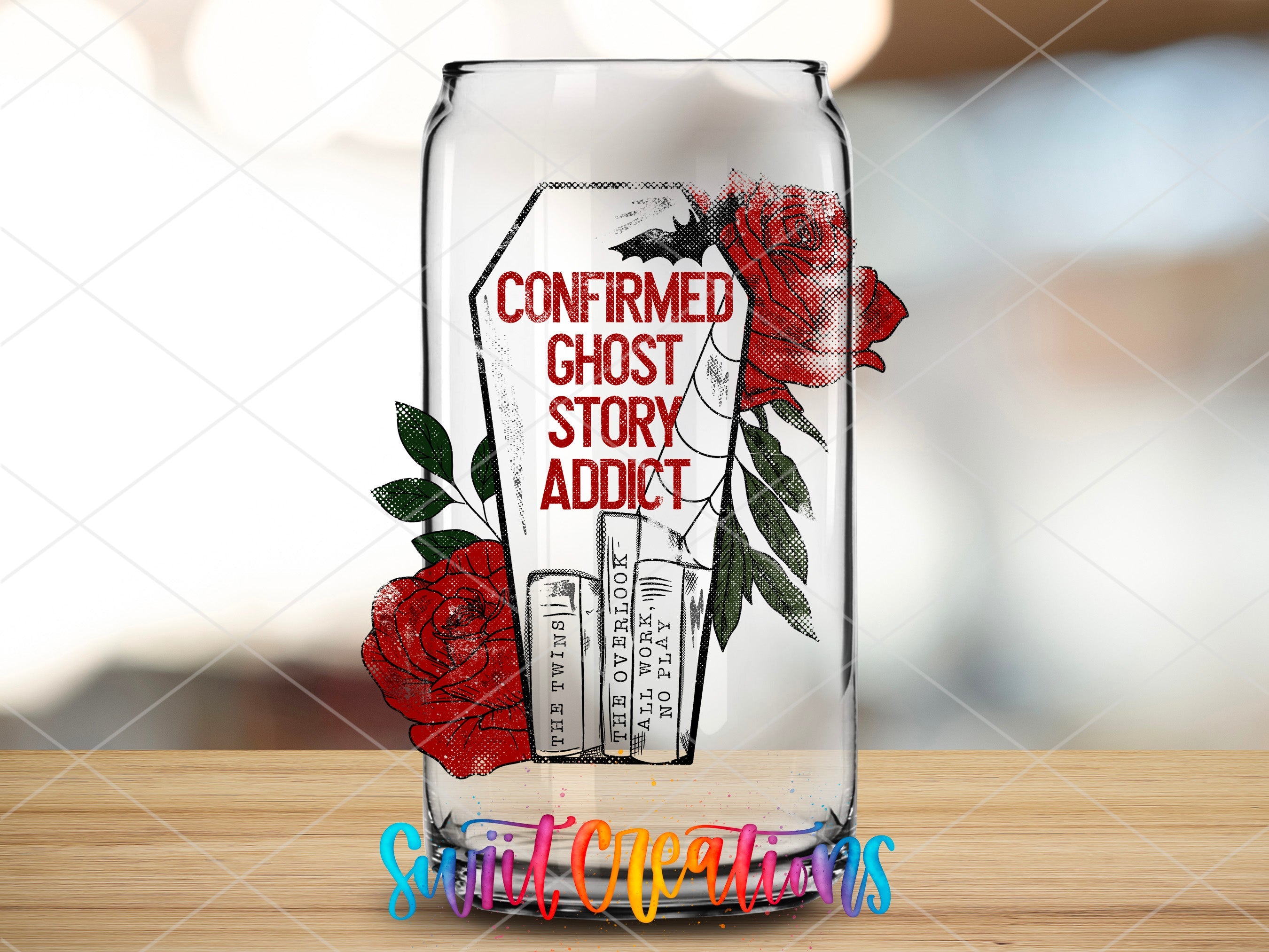 a glass jar with a red rose on it